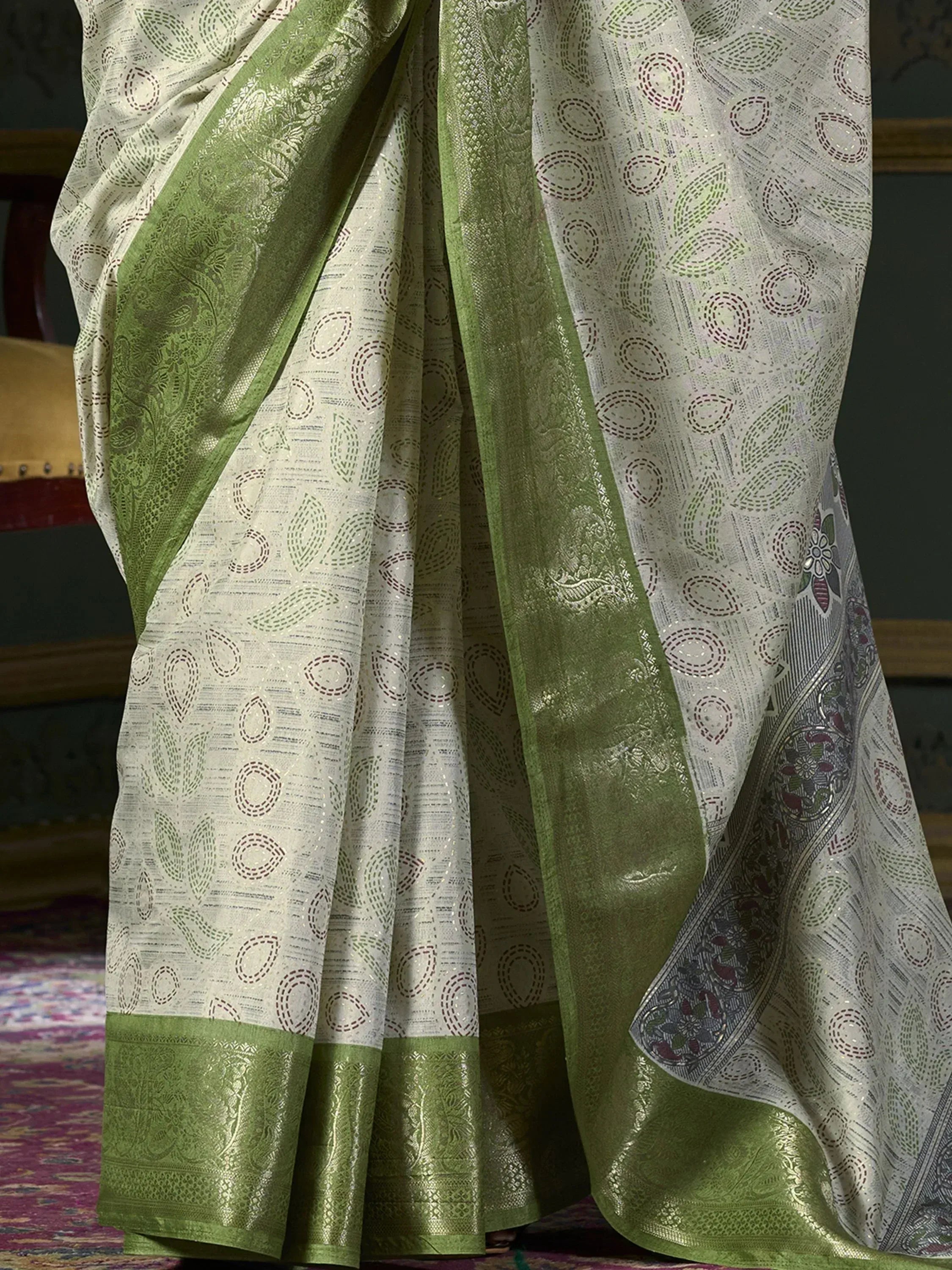 Elegant white and green ethnic saree with intricate paisley and circular motifs, perfect for Indian occasions.