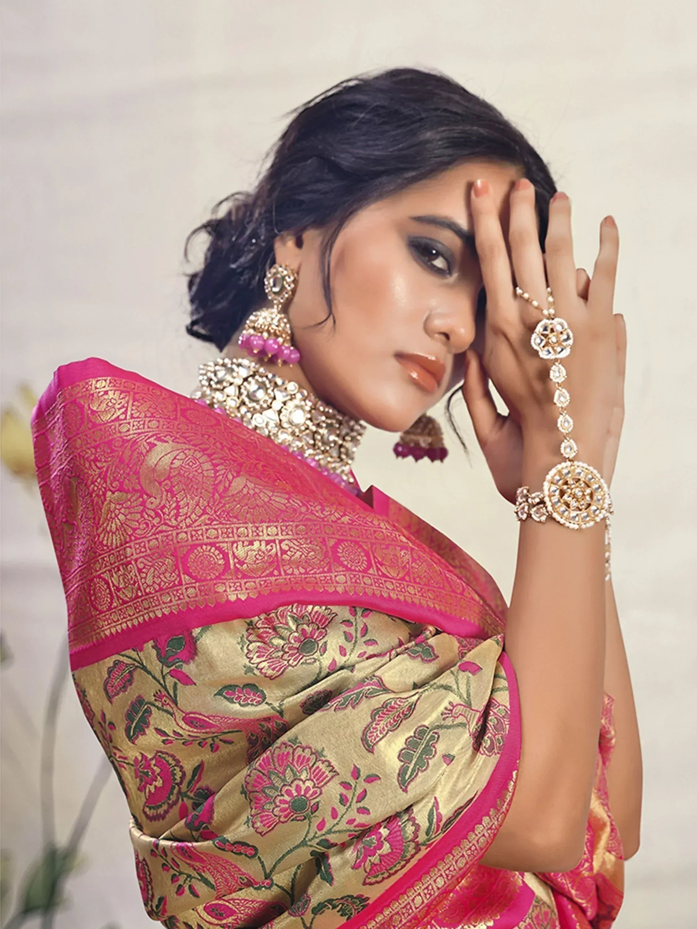 Pink and gold floral saree with heavy jewelry, perfect for Indian ethnic occasions