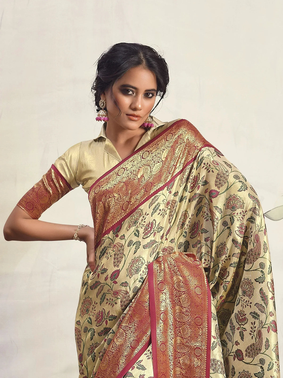 Elegant gold saree with floral and peacock print, rich red border, perfect for Indian ethnic wear occasions.