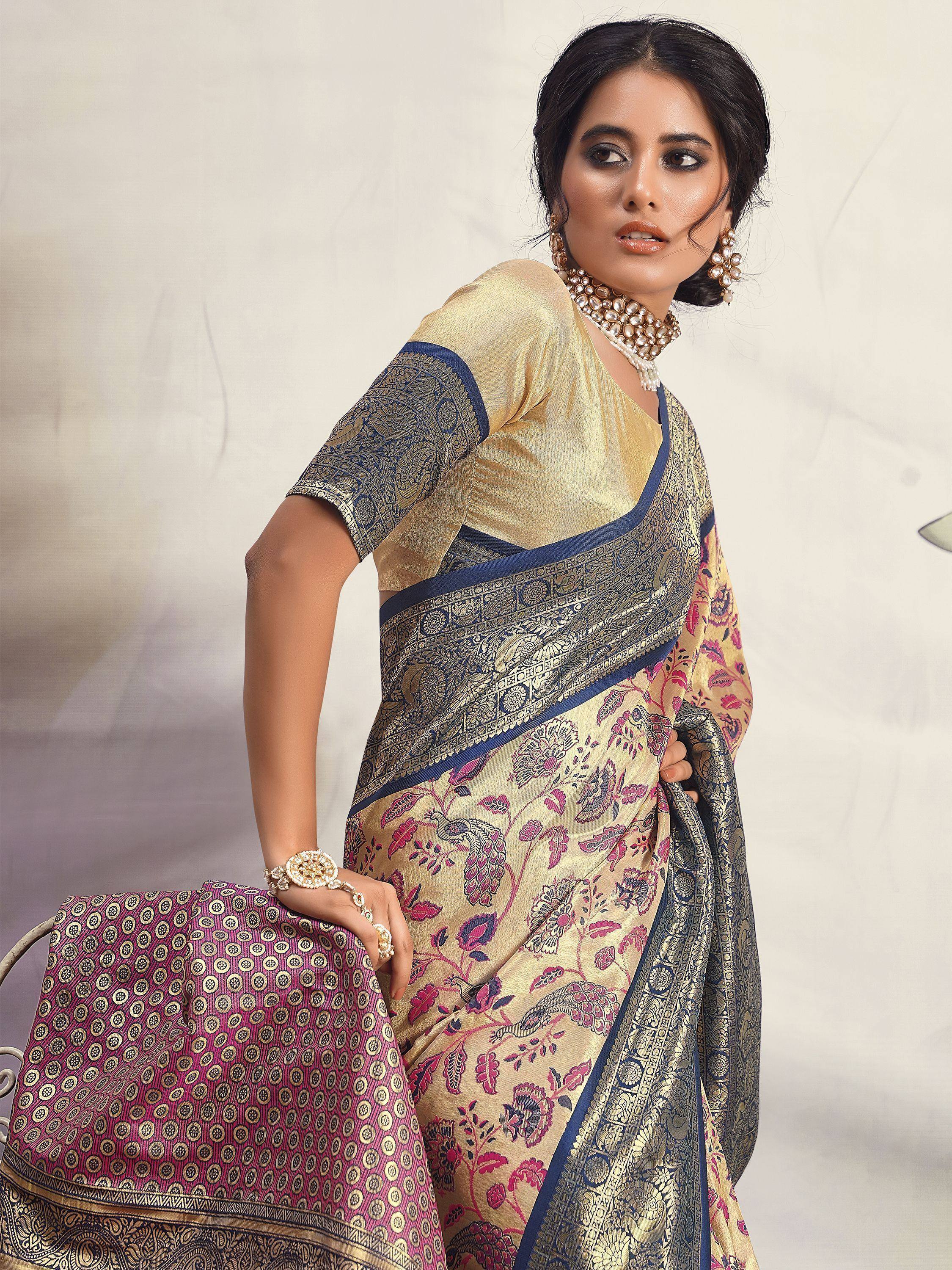 Elegant Indian saree with gold floral print, navy border, and matching blouse. Perfect for festive occasions.