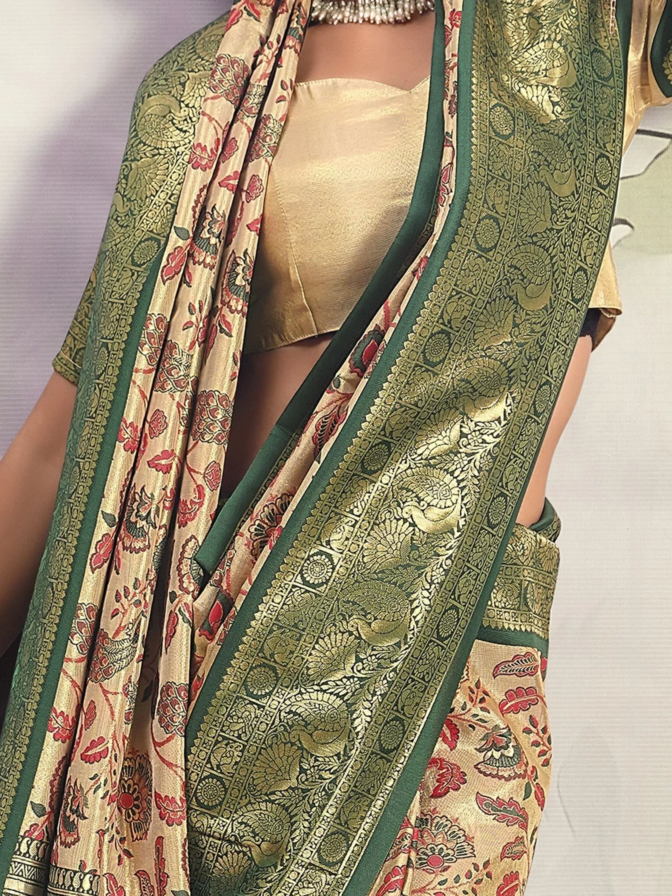 Green and gold floral saree with peacock motifs, paired with a golden blouse for Indian ethnic wear