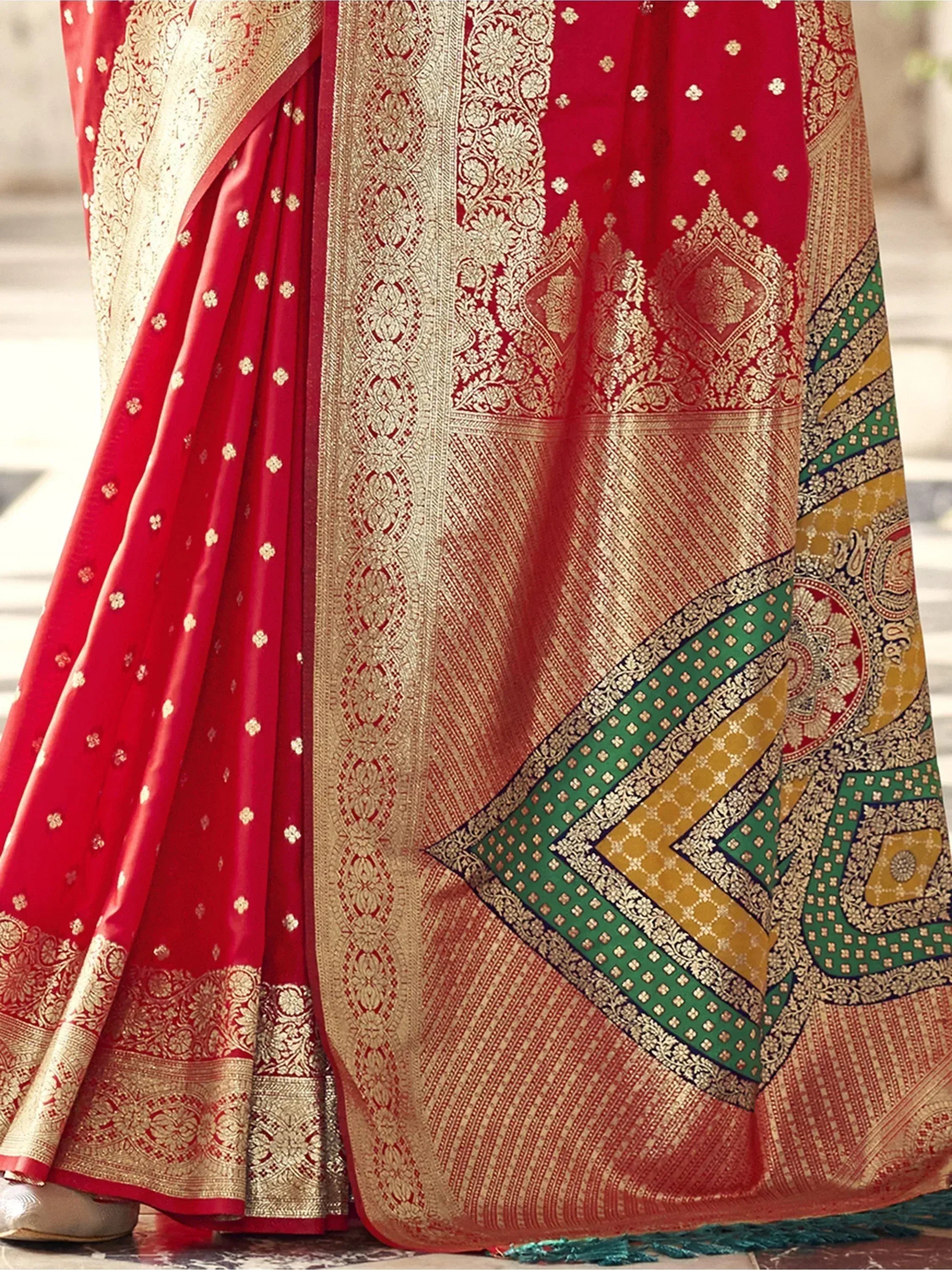 Red and gold designer saree with intricate zari work and green border, perfect for ethnic occasions