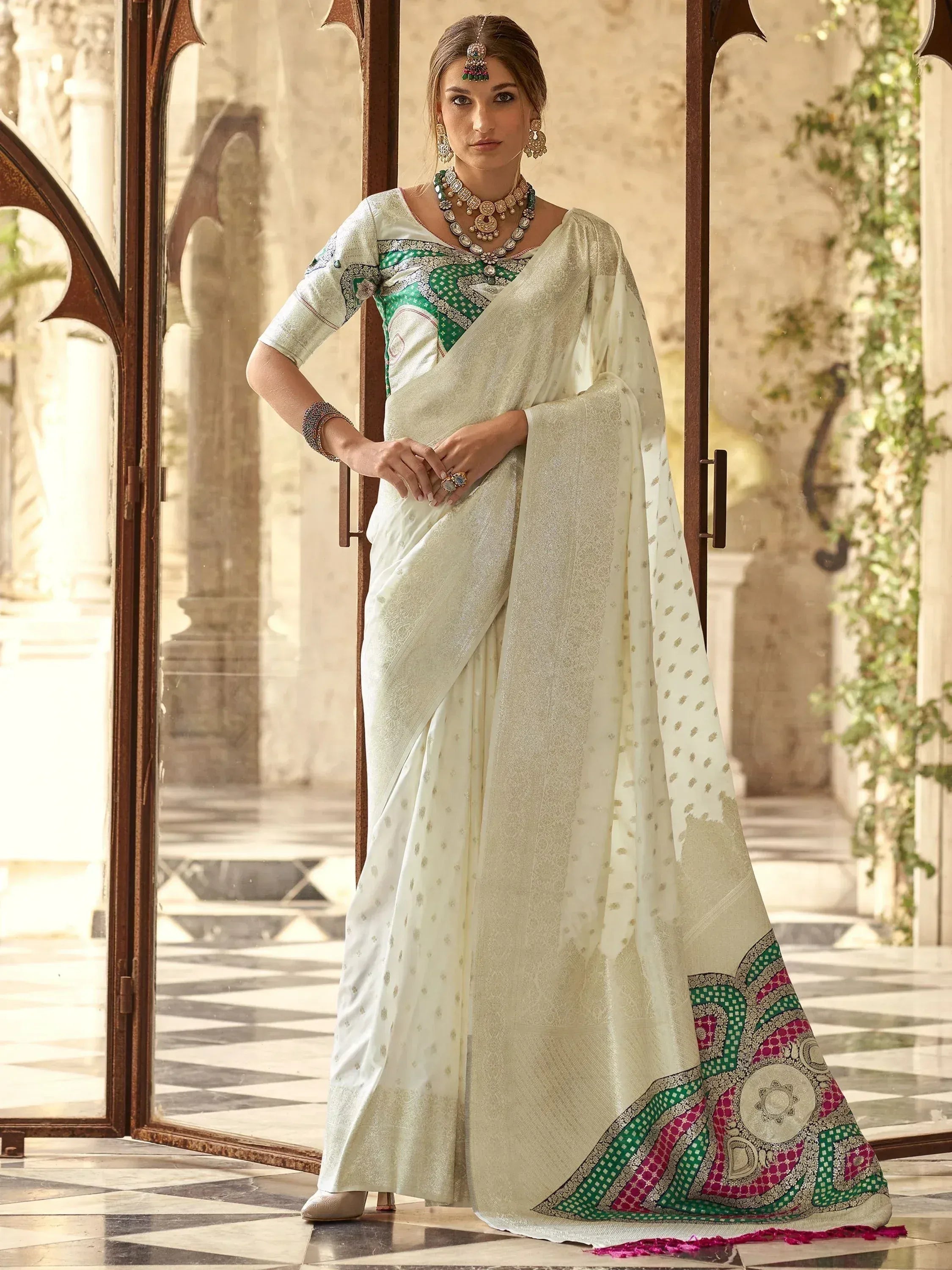 Elegant white saree with green and pink border, perfect for Indian ethnic wear occasions.