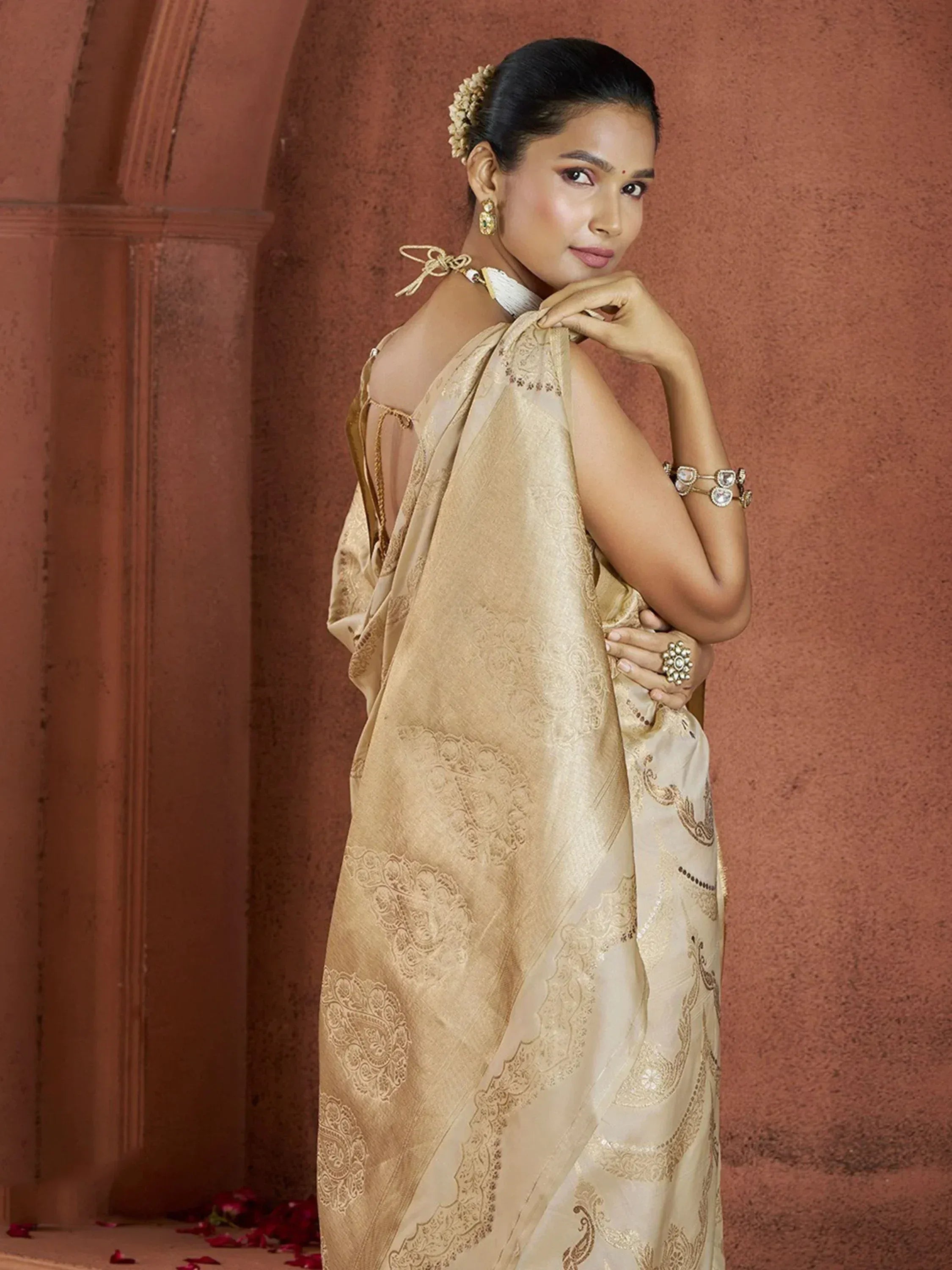 Elegant beige designer saree with gold embroidery, perfect for Indian ethnic wear occasions.