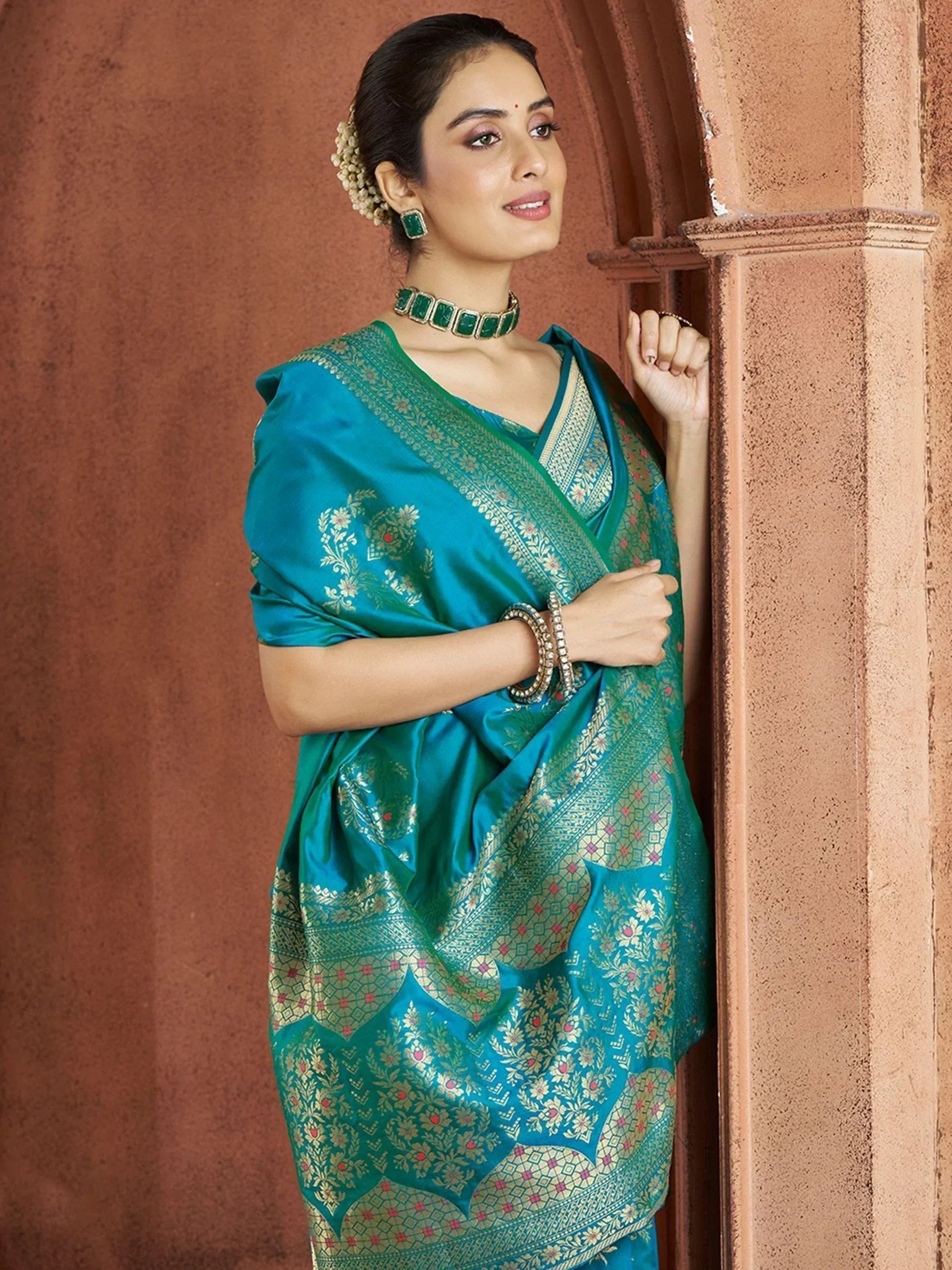 Teal silk saree with gold floral embroidery, perfect for Indian ethnic wear and festive occasions.