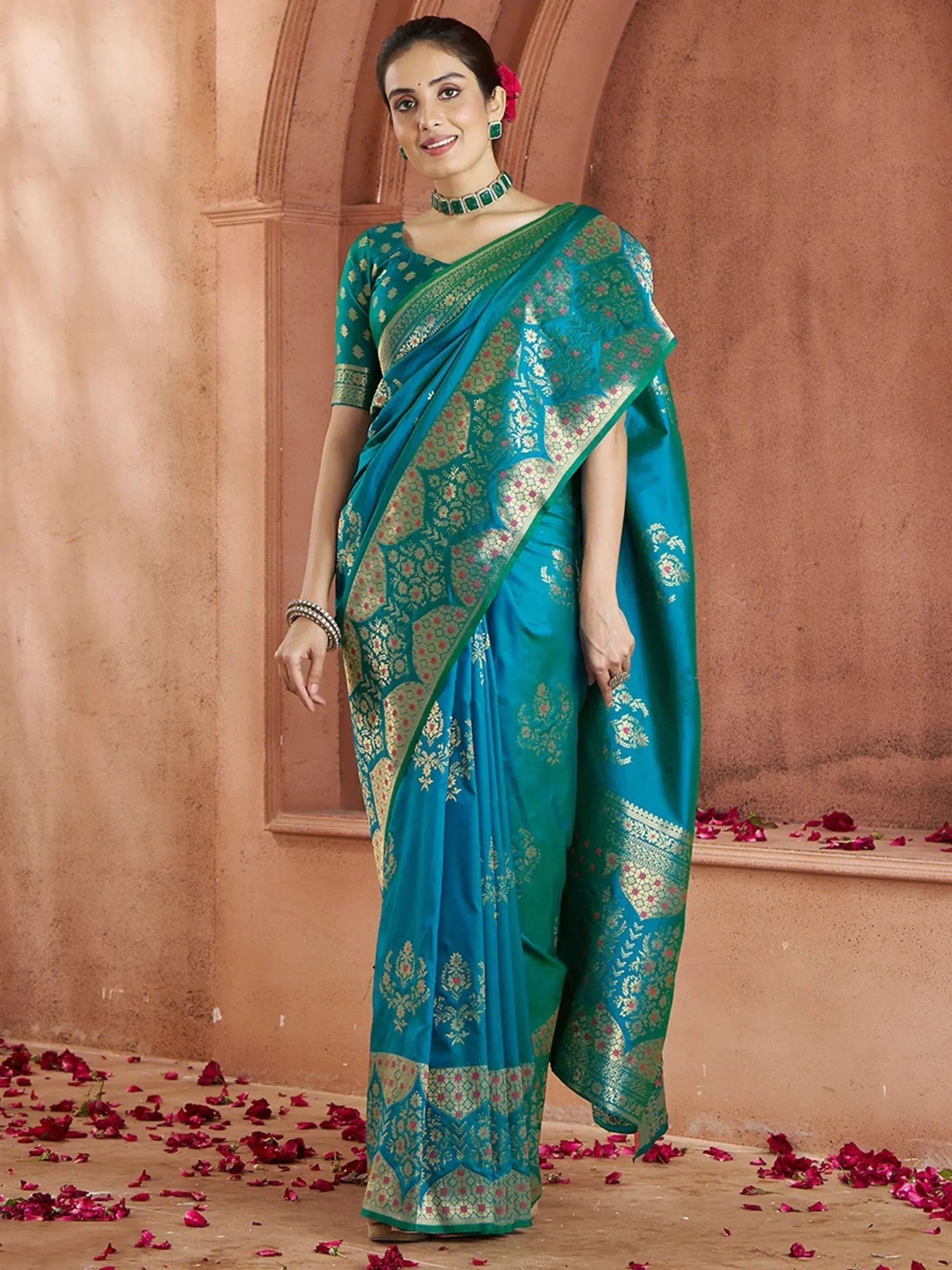 Teal blue designer saree with gold floral motifs and intricate border, perfect for ethnic occasions