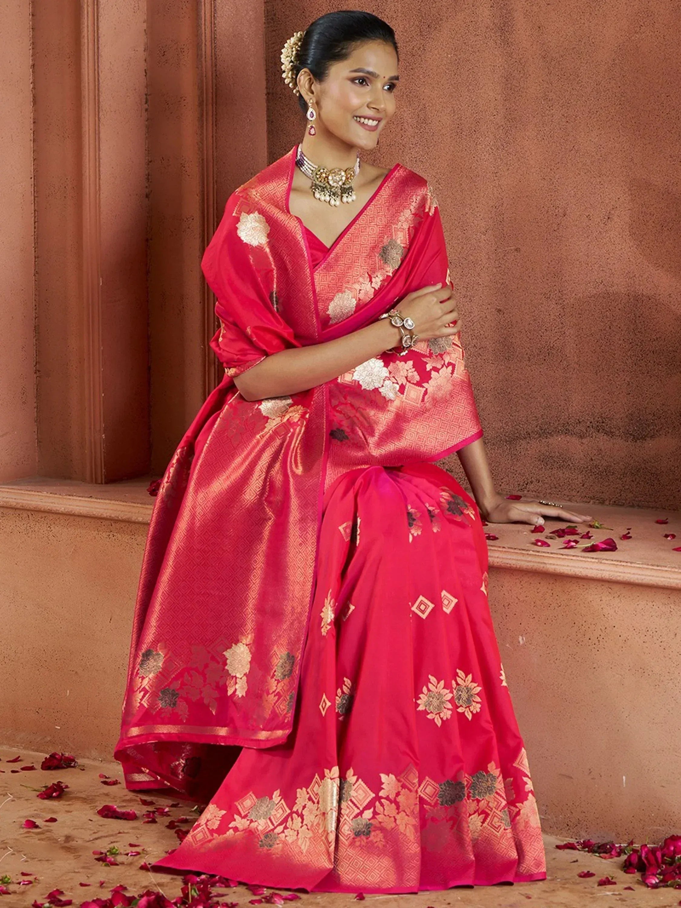 Vibrant pink ethnic saree with gold floral motifs, perfect for Indian weddings and festive occasions.