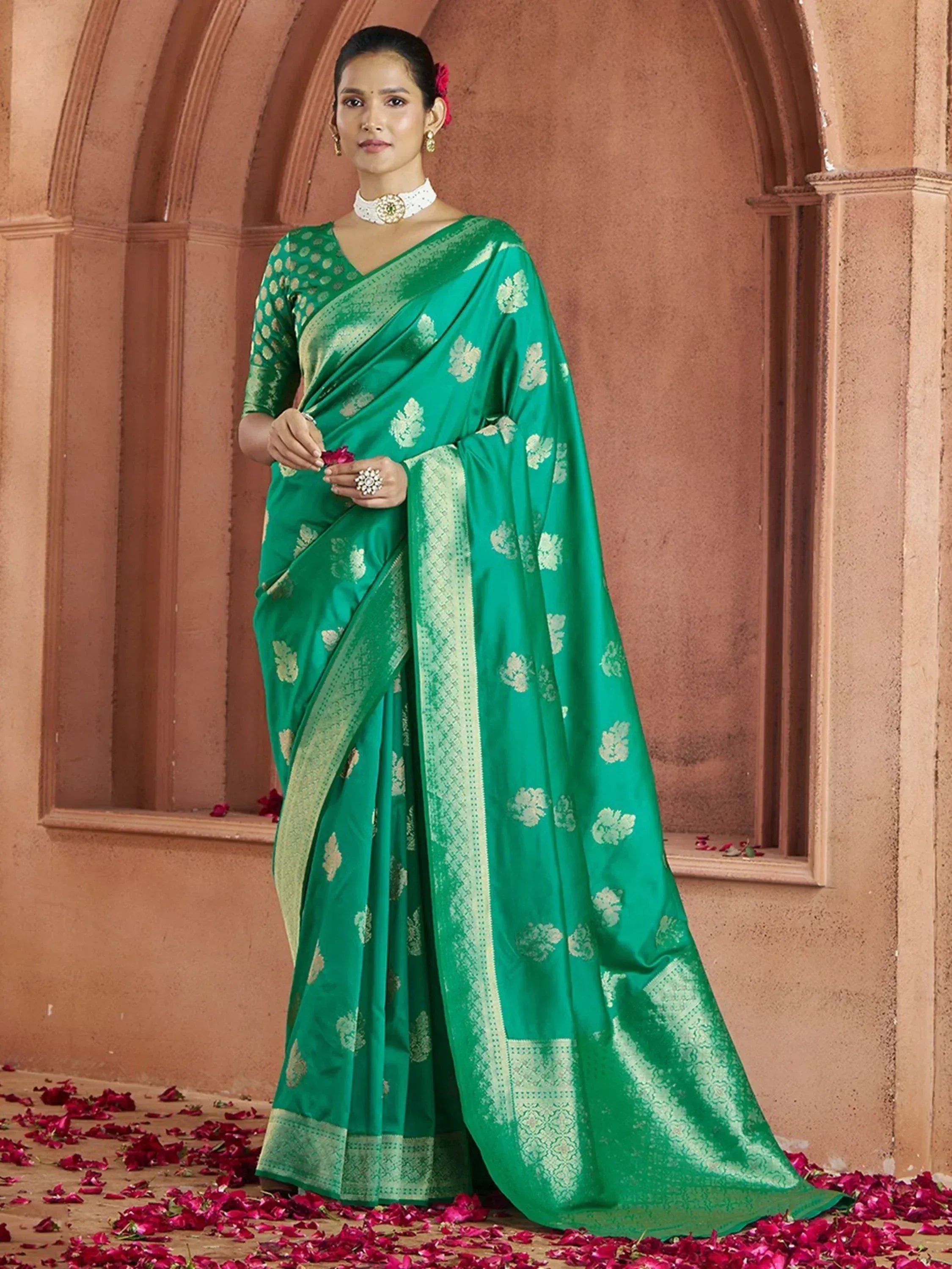 Emerald green designer saree with gold floral motifs and temple border, perfect for Indian ethnic occasions.