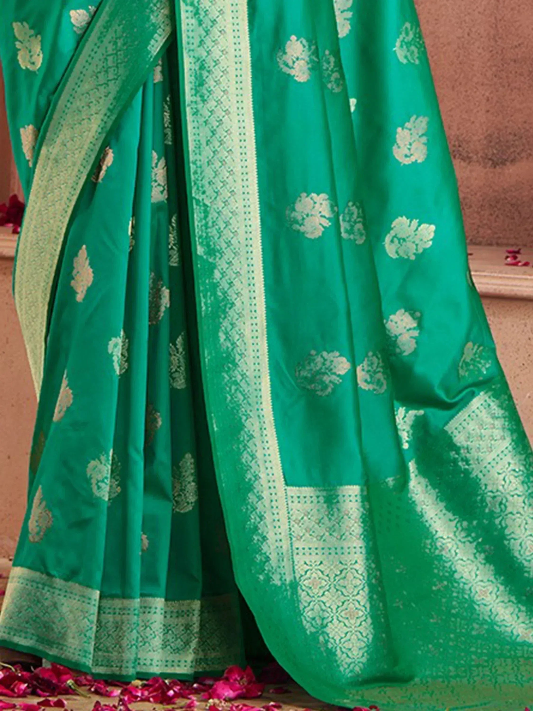 Emerald green designer saree with gold floral motifs and intricate border, perfect for ethnic occasions