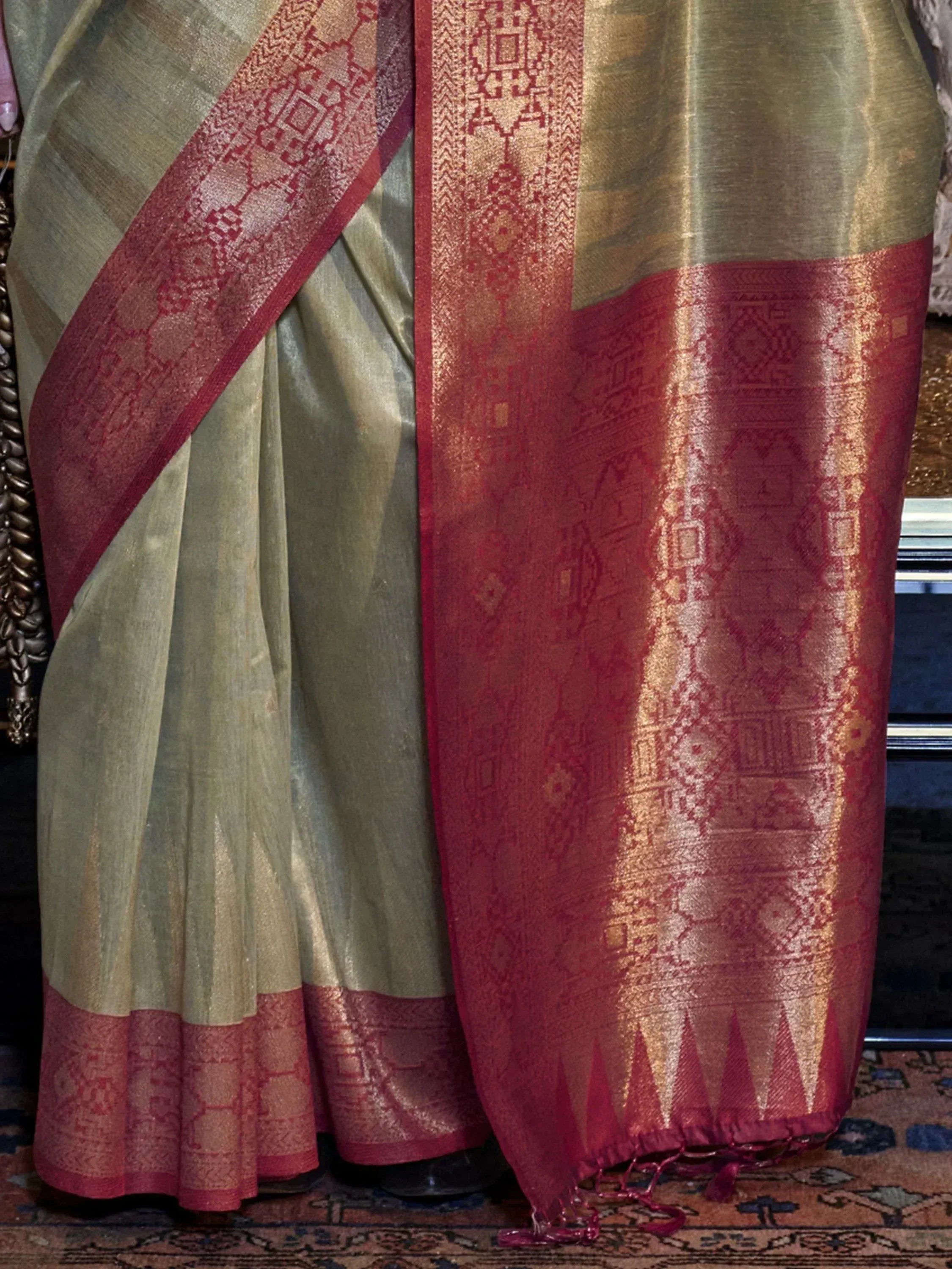 Olive green saree with red gold border, intricate woven patterns, ethnic Indian wear
