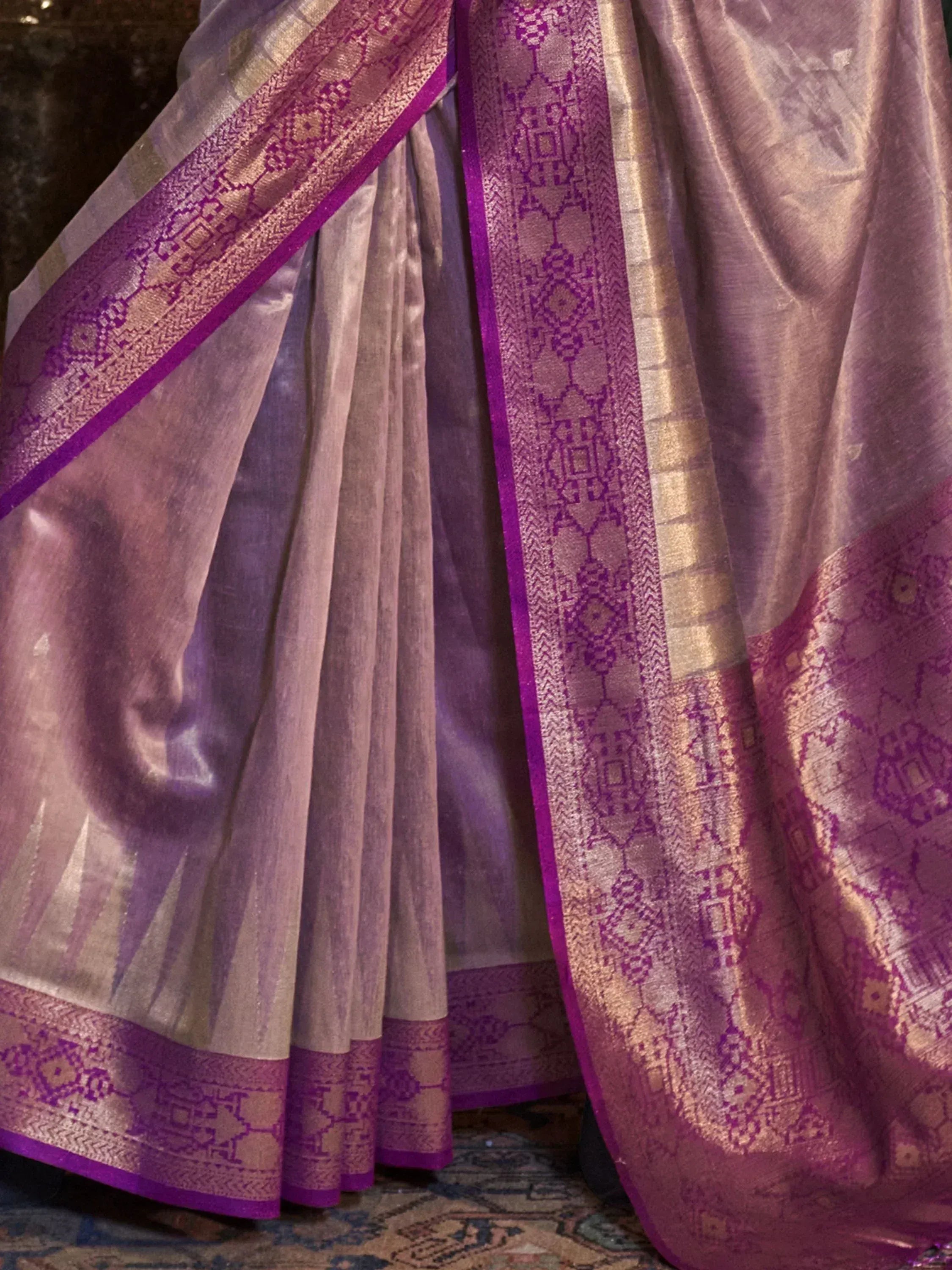Elegant purple and gold designer saree with intricate woven border, perfect for Indian ethnic wear occasions.