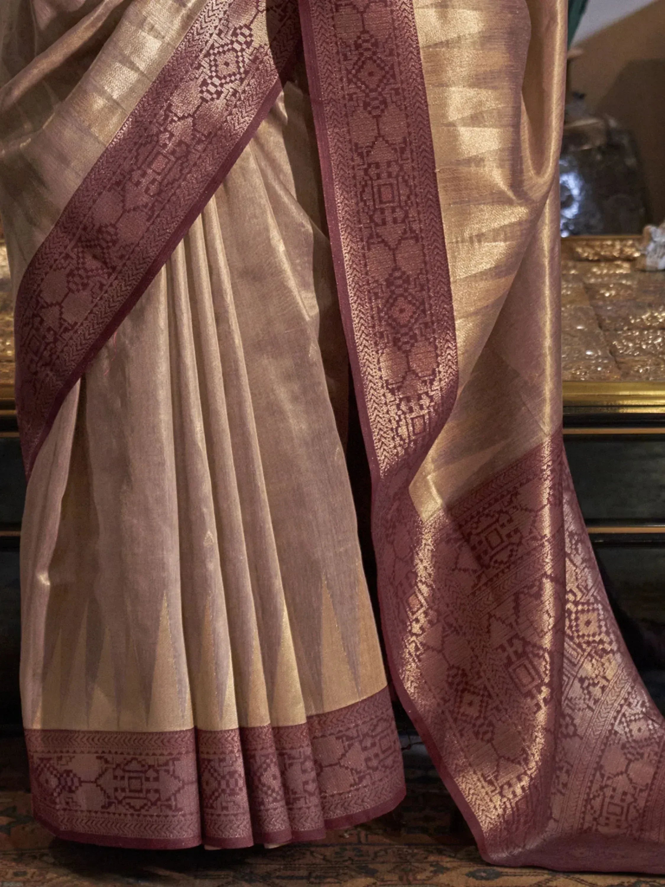 Elegant beige and maroon saree with intricate geometric border, perfect for Indian ethnic wear occasions.