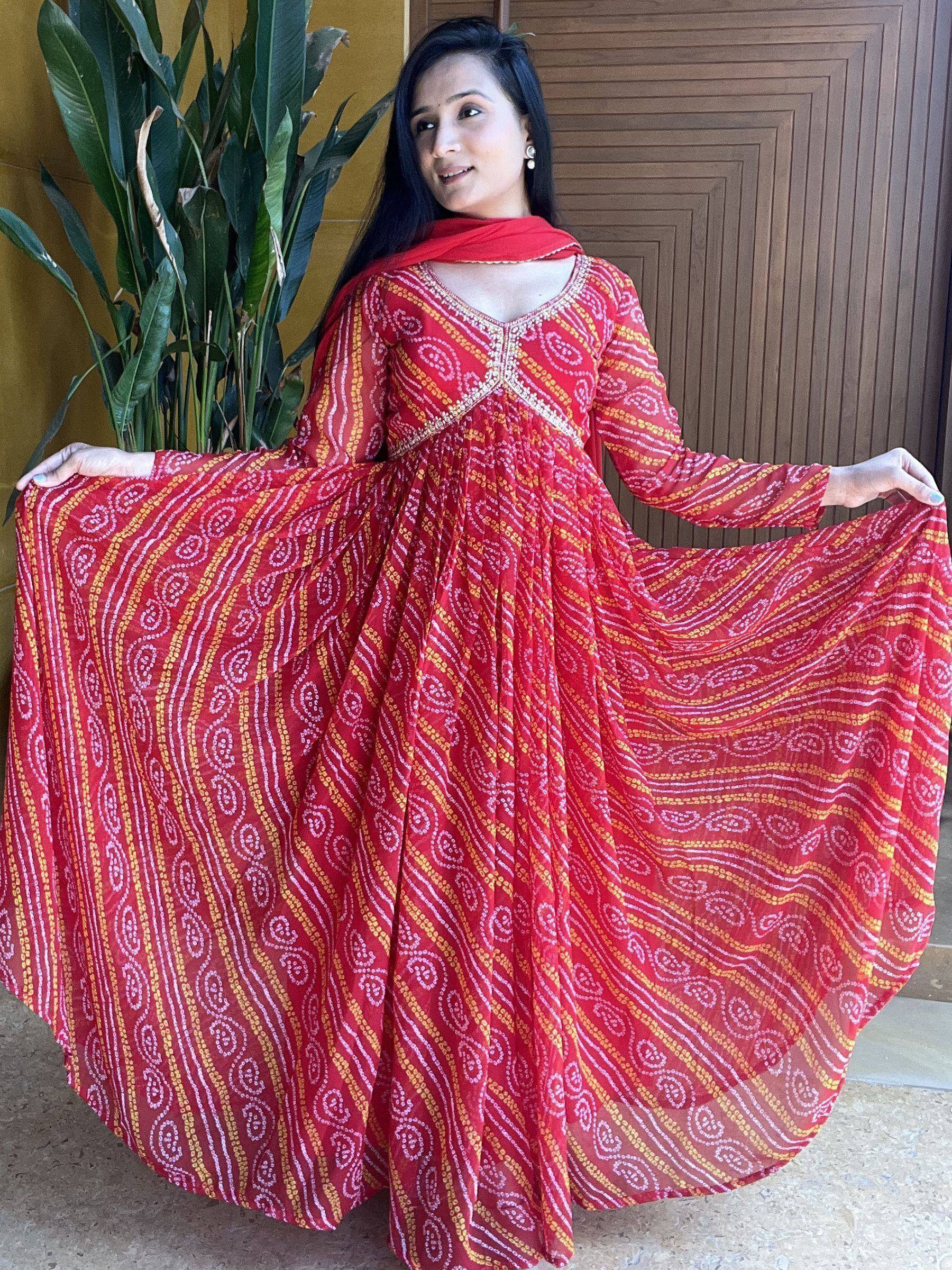 Red printed ethnic gown with yellow and white patterns, long sleeves, and flared skirt for women