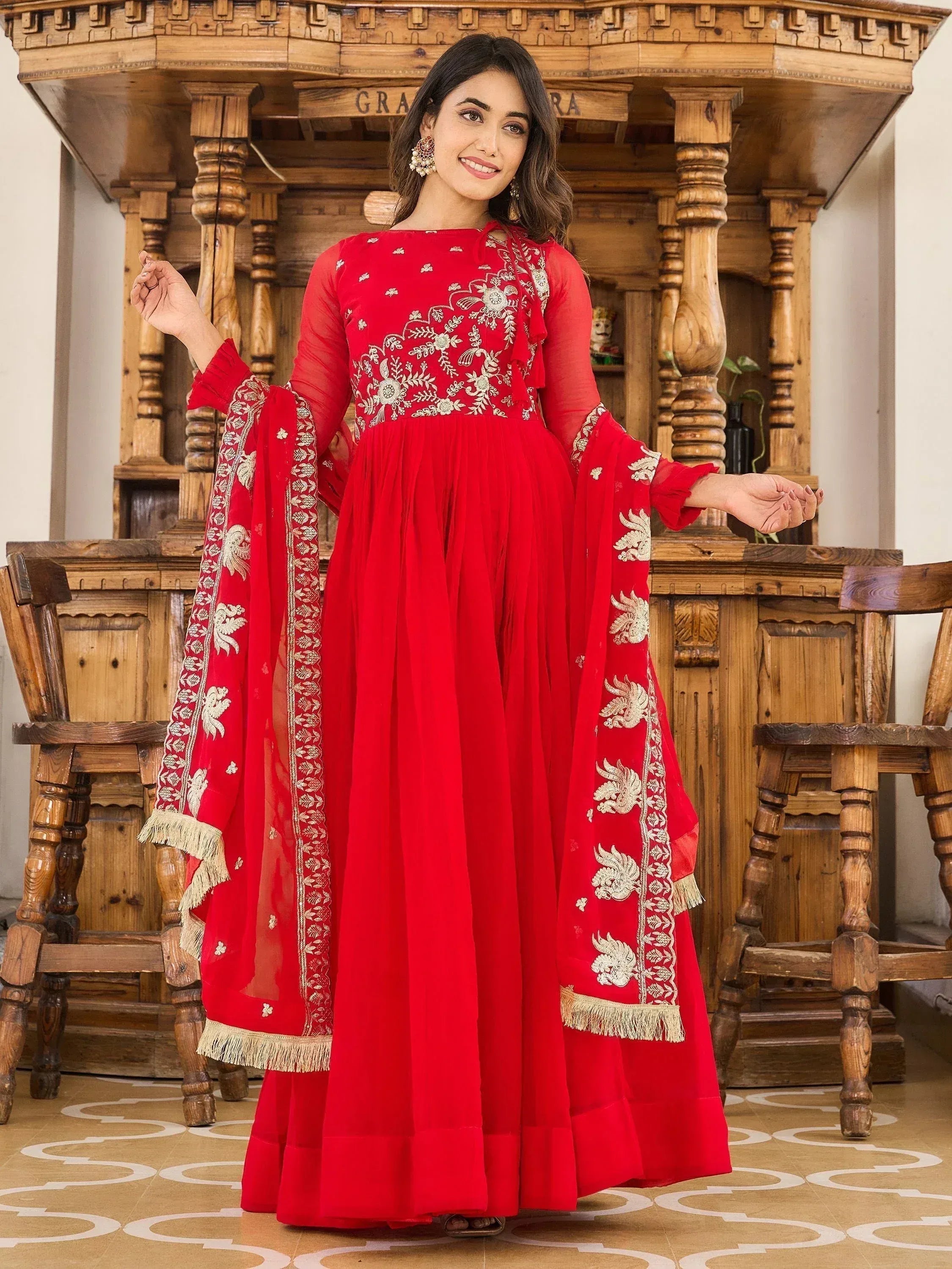 Red embroidered ethnic gown with gold detailing, perfect for Indian festive occasions and weddings.
