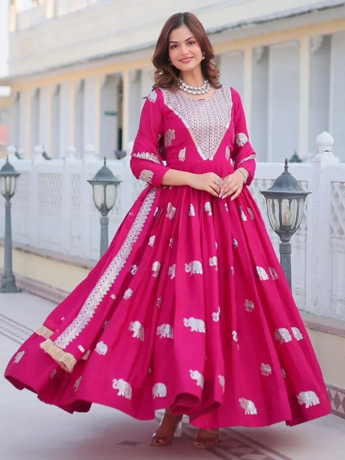 Fuchsia ethnic gown with silver elephant print and embroidery, perfect for Indian festive occasions