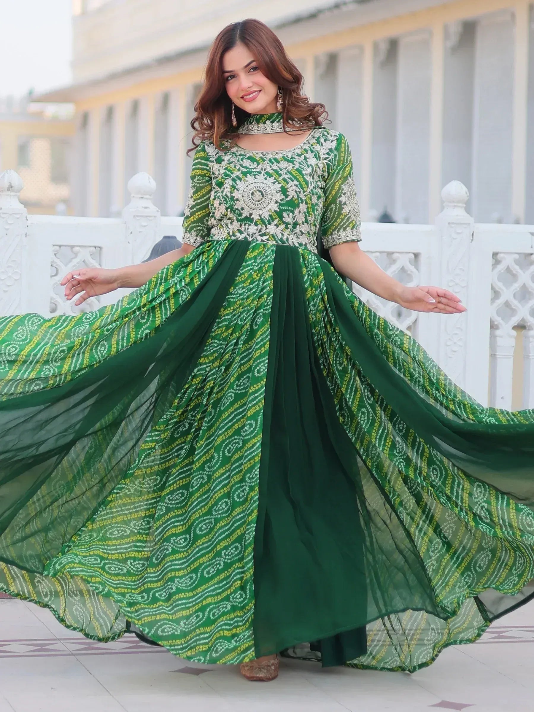 Green embroidered ethnic gown with flared skirt, perfect for festive occasions and Indian wear.