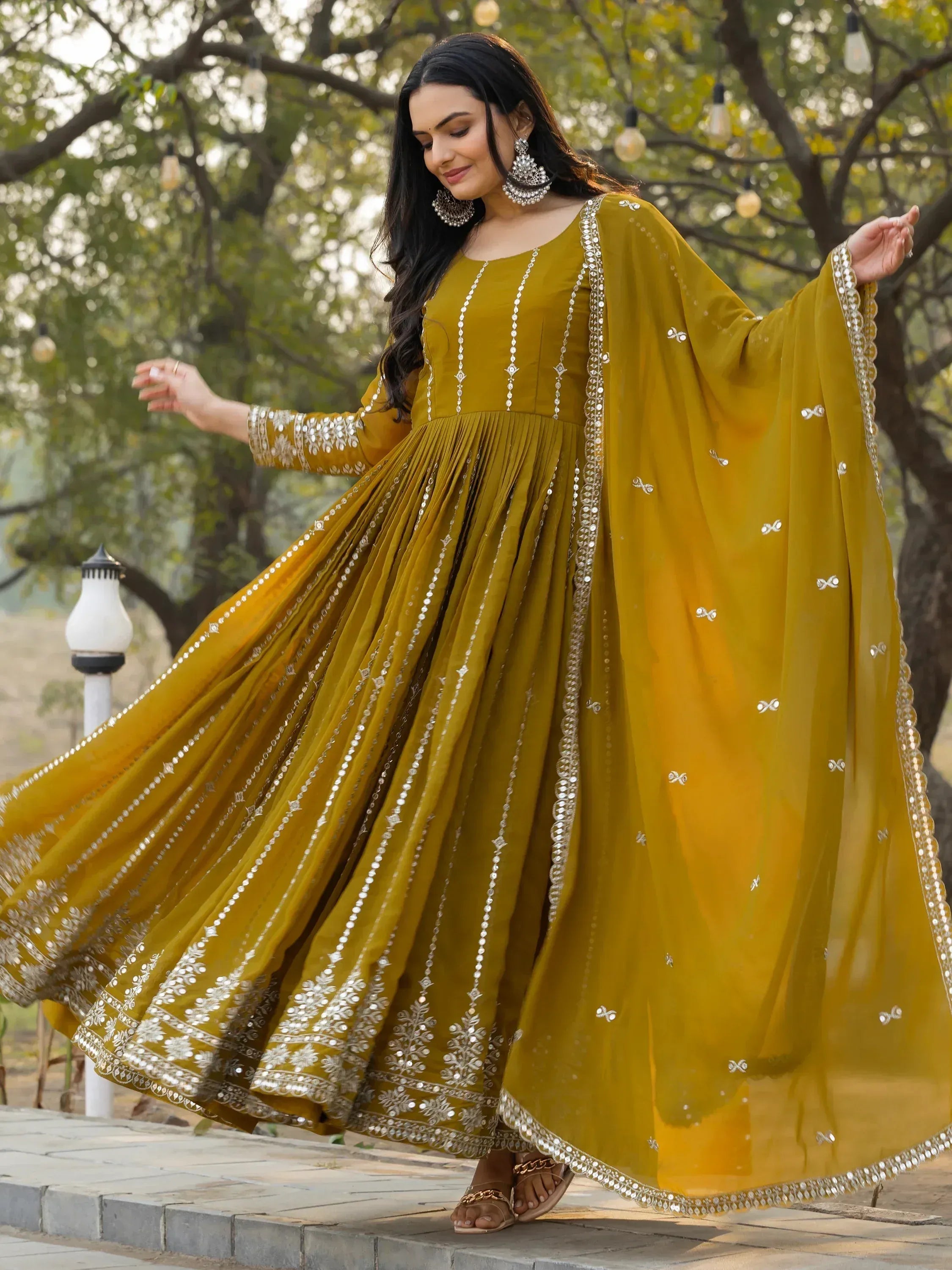 Mustard yellow ethnic gown with mirror work, perfect for Indian occasions and festive wear.