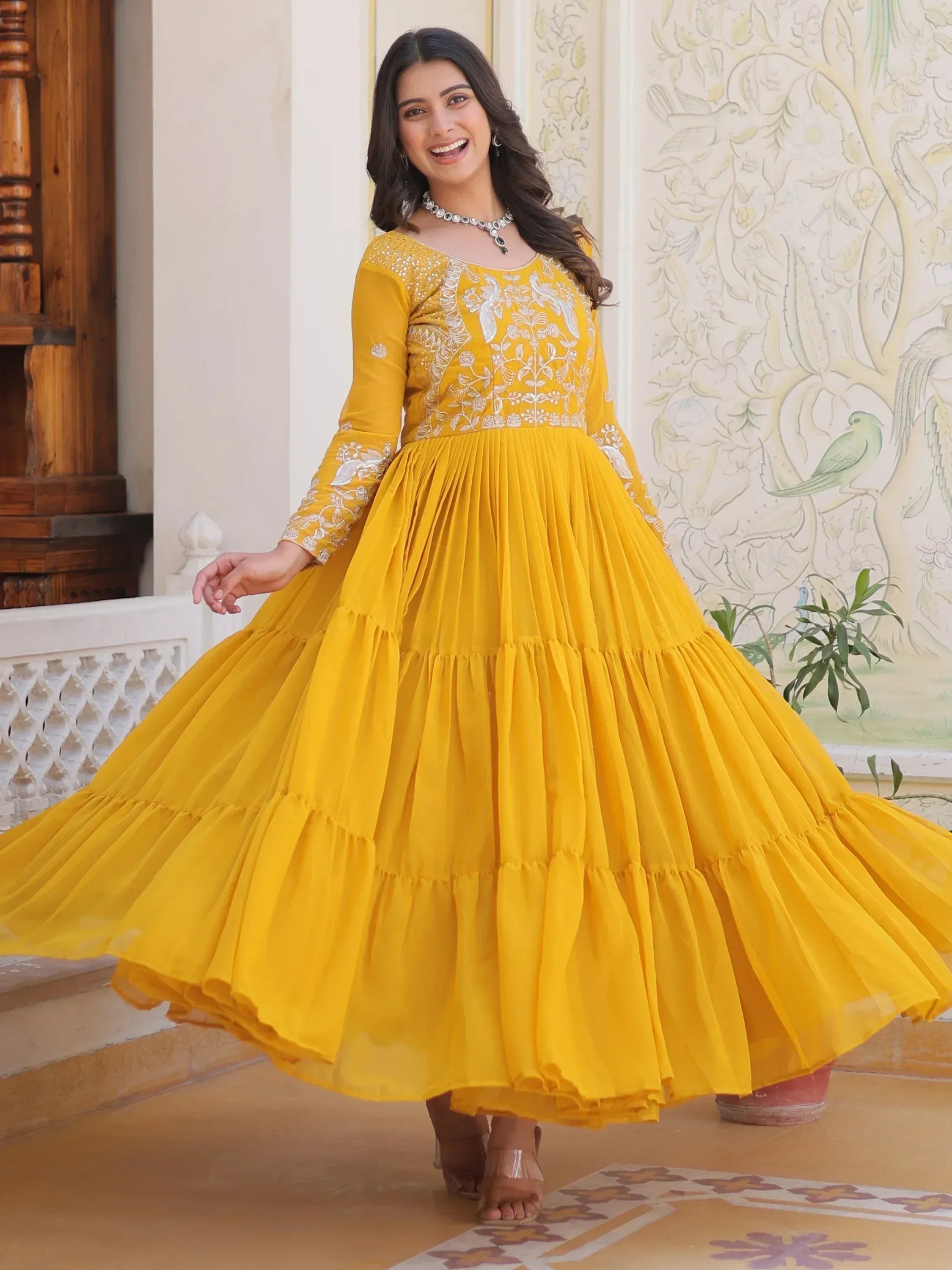 Yellow embroidered ethnic gown with flared skirt, perfect for Indian festive occasions and weddings.