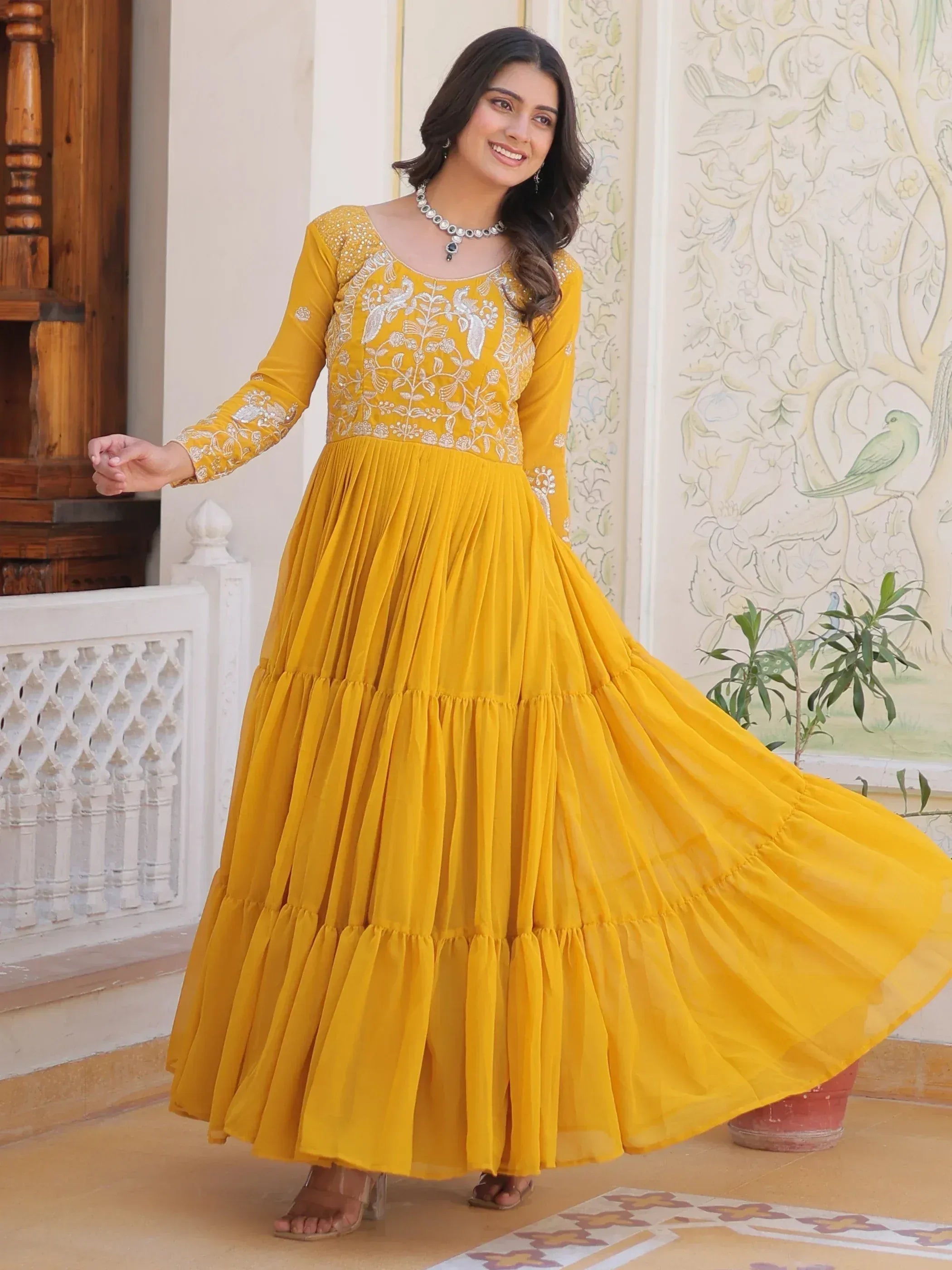 Yellow ethnic gown with white embroidery, pleated skirt, perfect for Indian occasions