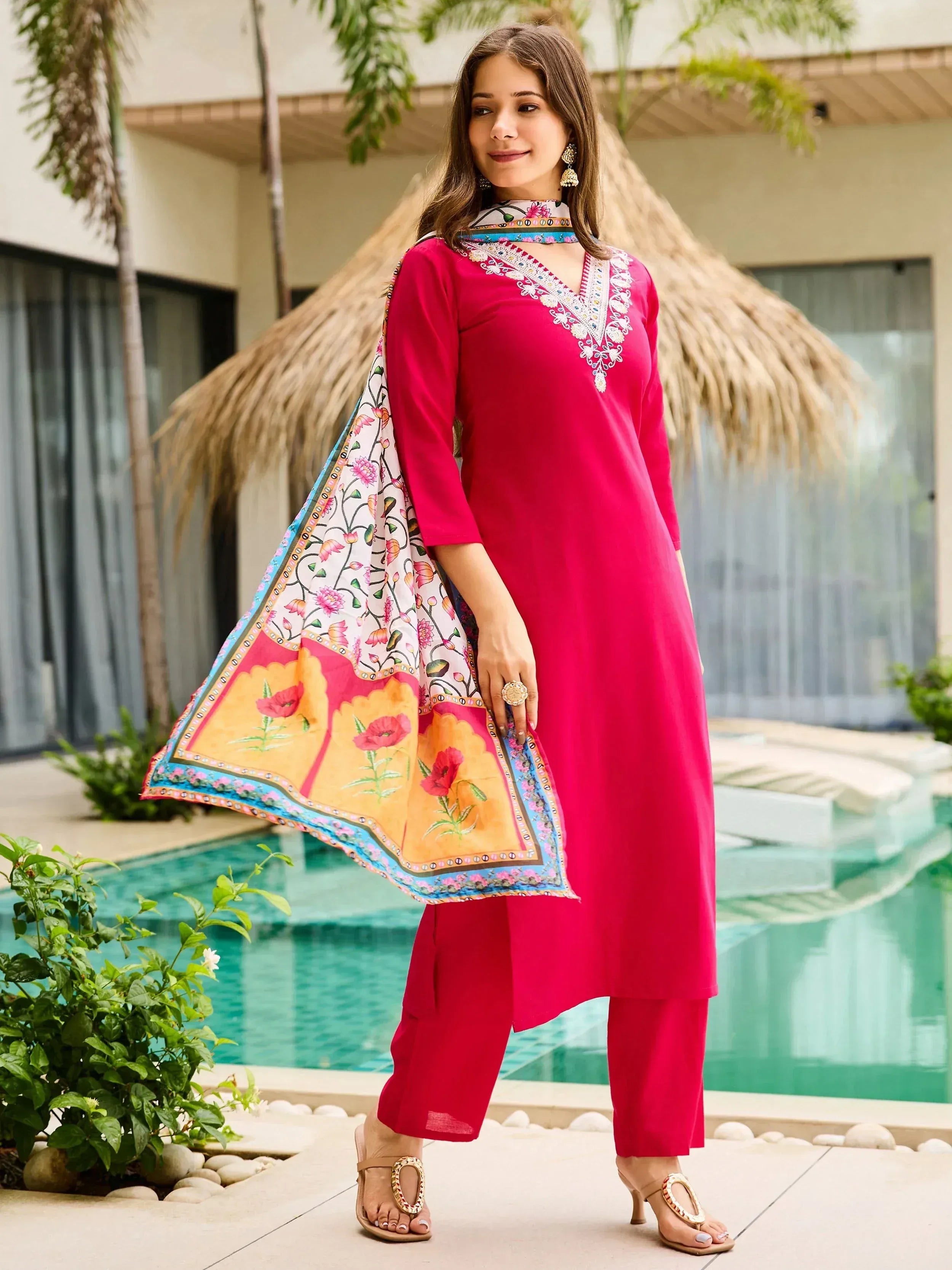 Vibrant pink embroidered kurta with floral dupatta, styled for ethnic wear near poolside