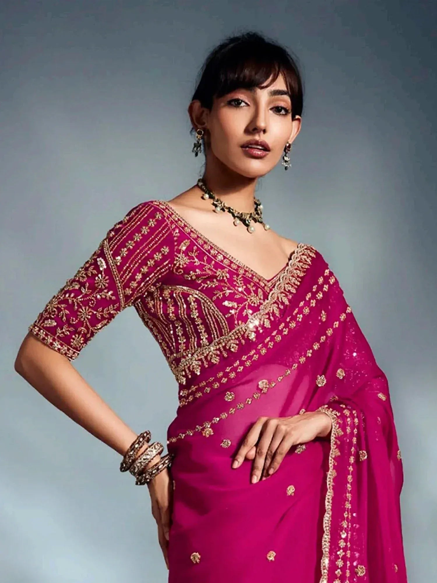 Fuchsia embroidered saree with gold detailing, perfect for Indian ethnic wear and festive occasions.