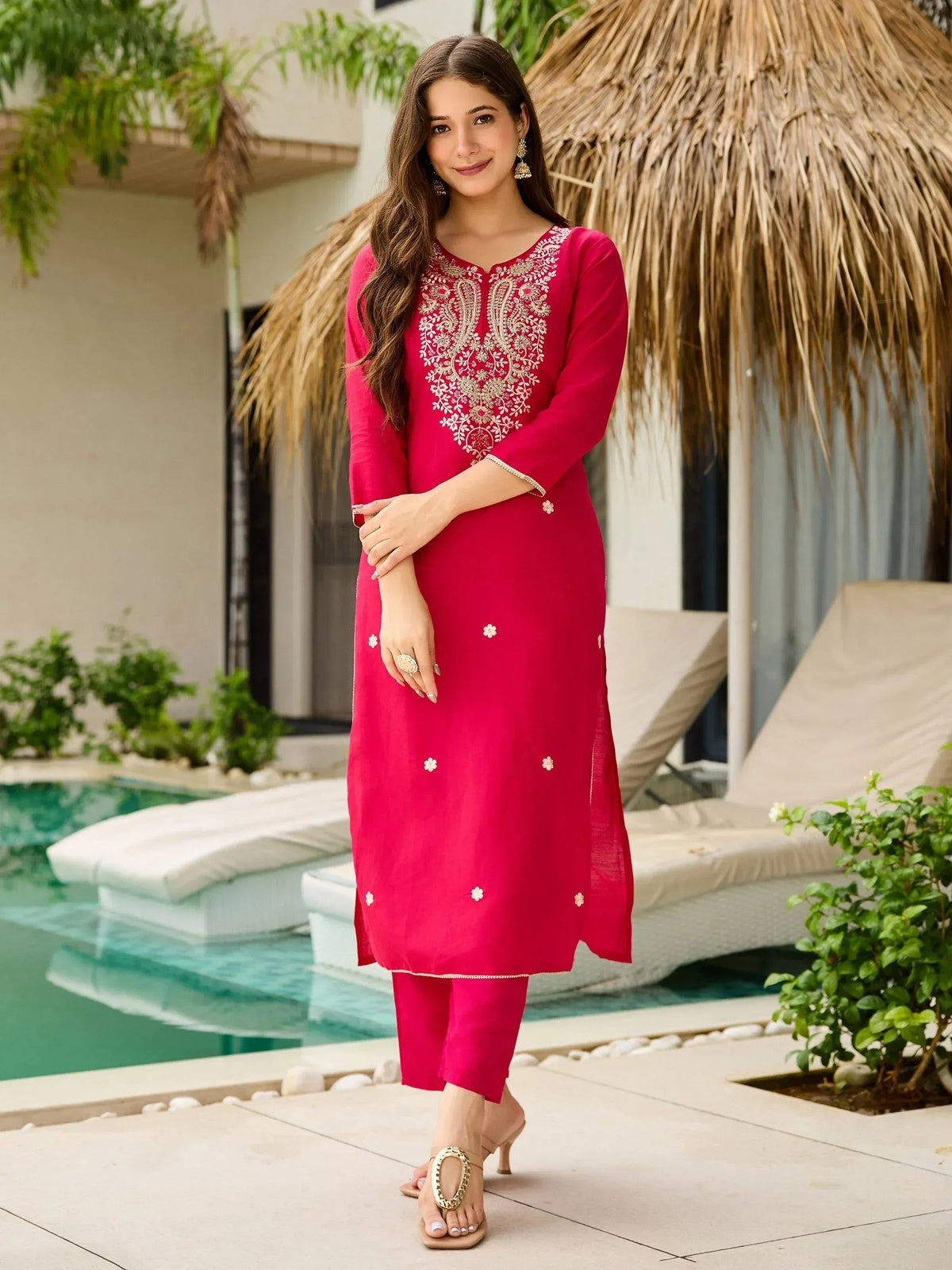 Woman in pink embroidered kurta and pants, poolside ethnic wear