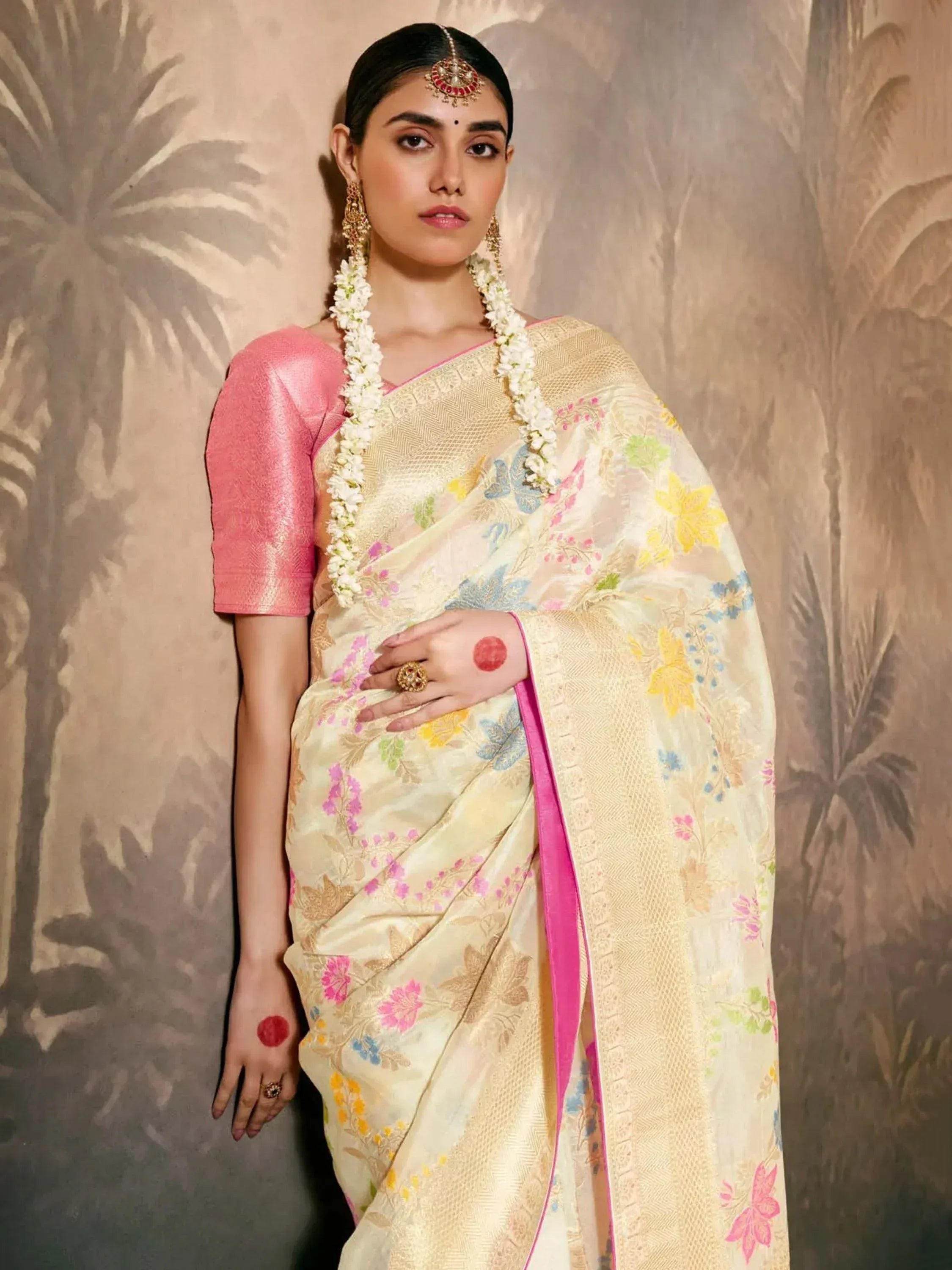 Woman in floral printed saree with pink blouse, traditional Indian ethnic wear, perfect for weddings and festivals