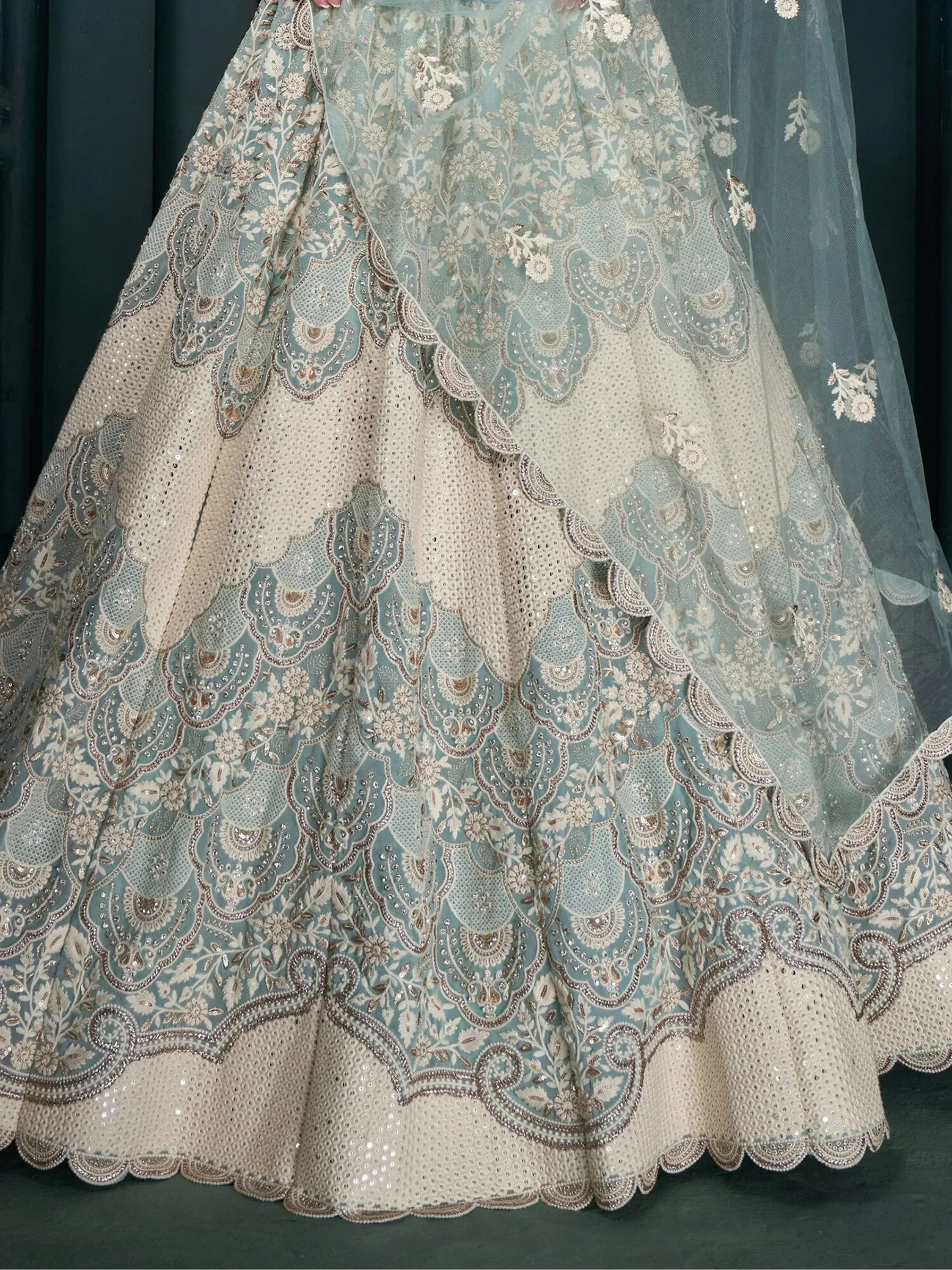 Designer lehenga choli with intricate floral embroidery and sequin work in pastel blue and cream