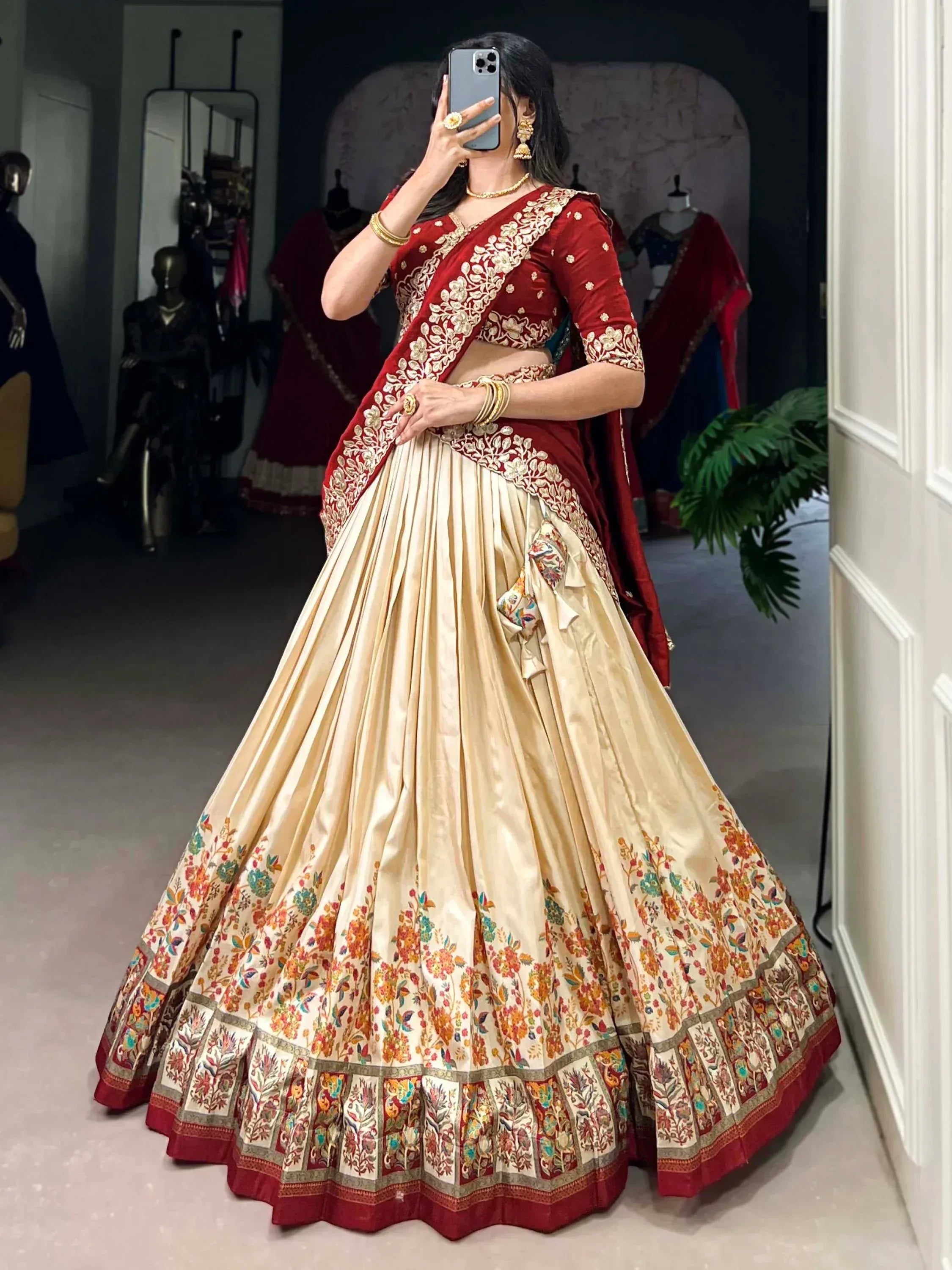 Red and cream designer lehenga choli with floral embroidery, perfect for Indian weddings and festive occasions.