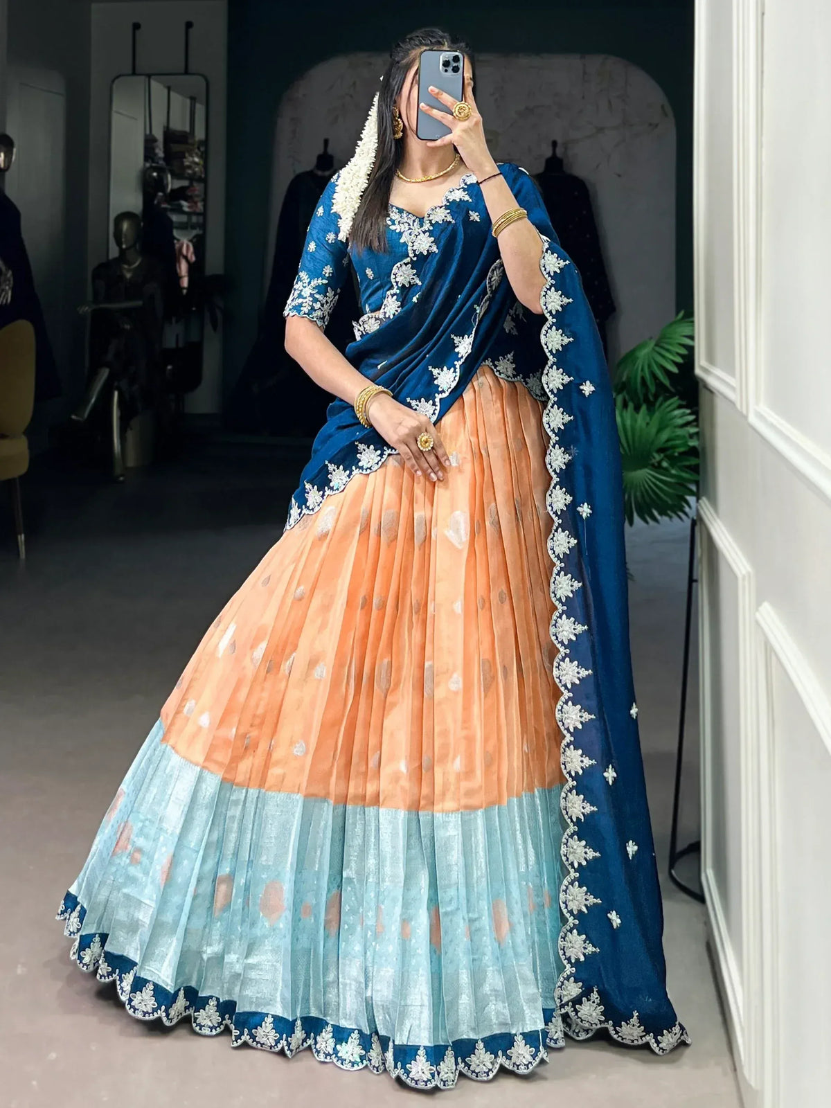 Blue and peach designer lehenga choli with white floral embroidery, perfect for Indian ethnic wear occasions.