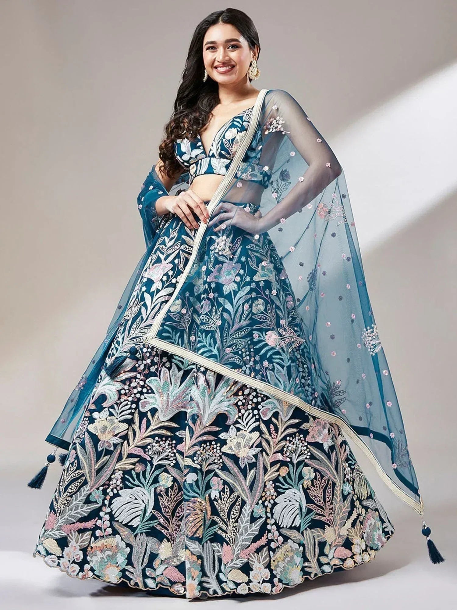 Elegant teal lehenga choli with floral embroidery and sheer dupatta for Indian ethnic wear