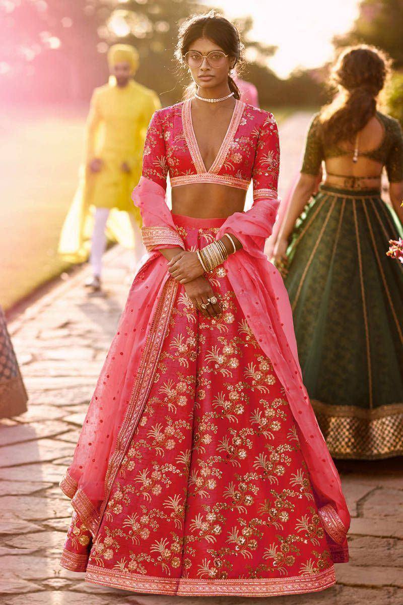 Pink floral embroidered lehenga choli with gold detailing, perfect for Indian weddings and festive occasions.