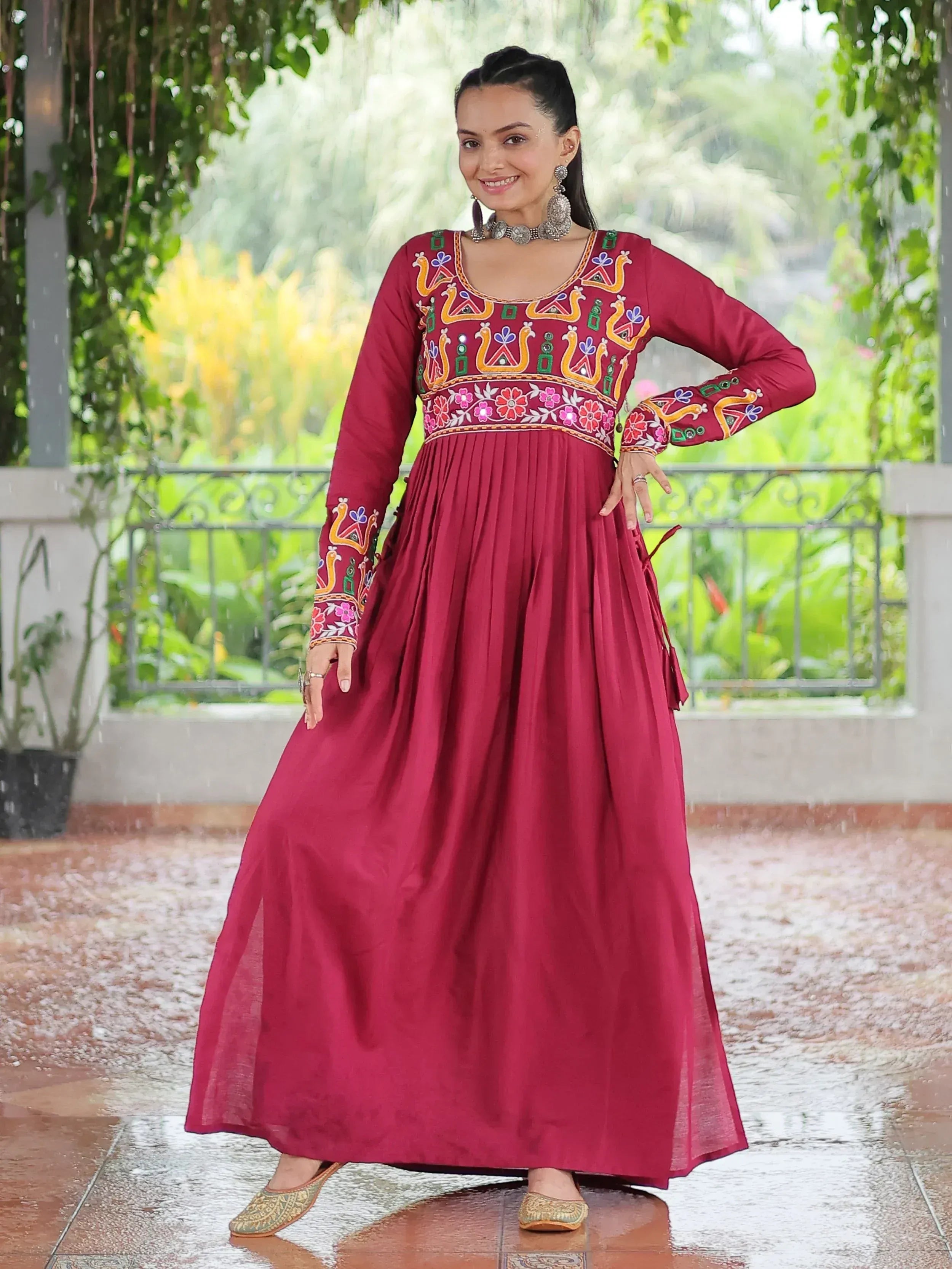 Maroon embroidered ethnic gown with floral and peacock motifs, perfect for Indian festive wear