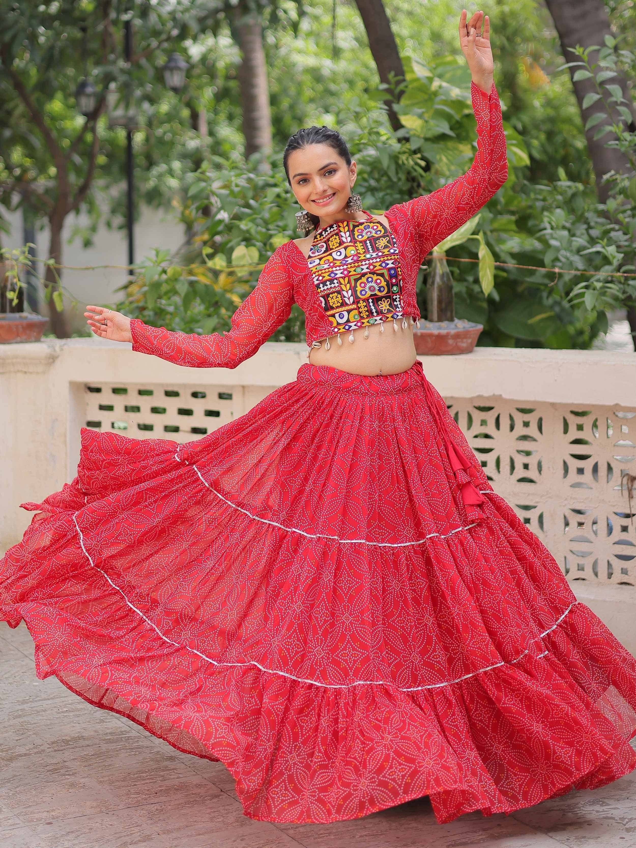 Red ethnic lehenga choli with mirror work and flared skirt, perfect for festive occasions