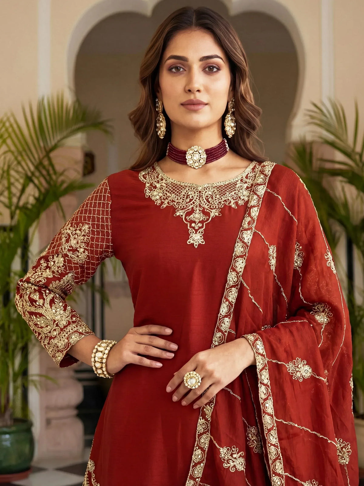 Red ethnic salwar kameez with gold embroidery, perfect for Indian weddings and festive occasions