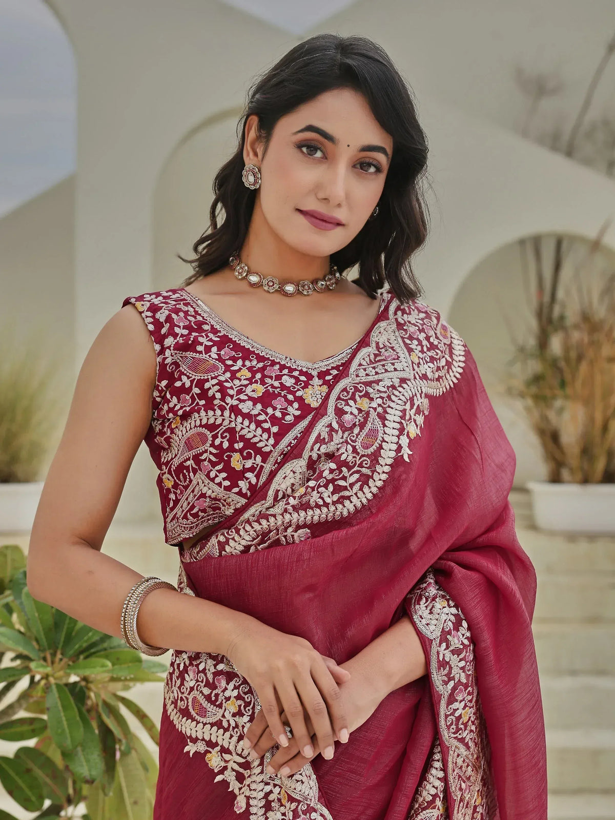 Elegant maroon saree with intricate floral embroidery and designer blouse