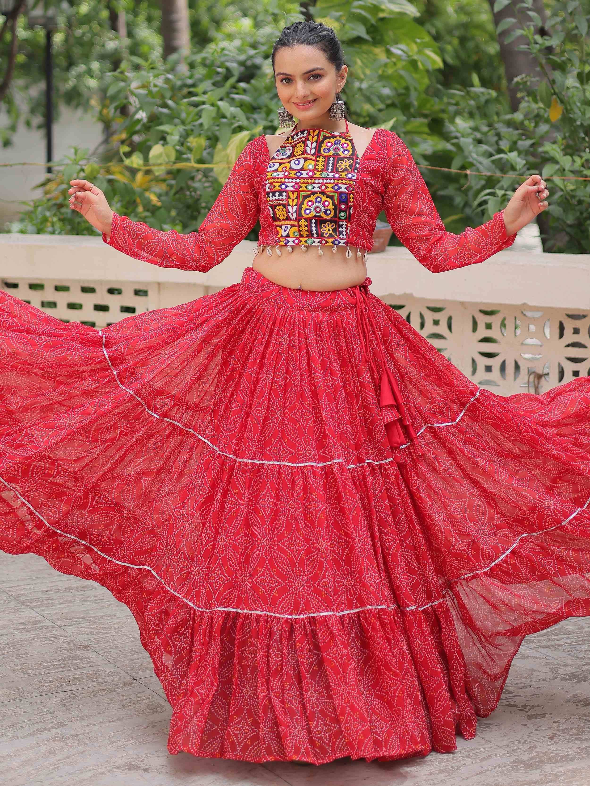 Red ethnic lehenga choli with mirror work and flared skirt, perfect for Indian festive occasions