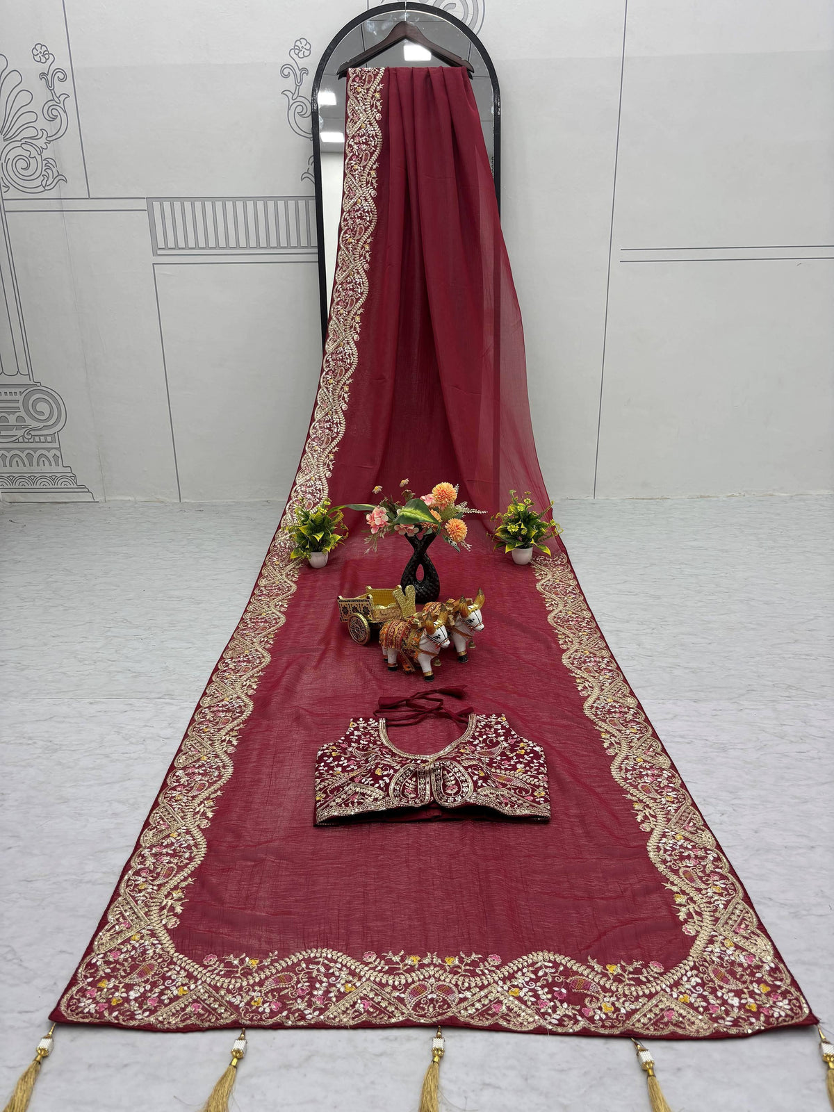 Maroon embroidered lehenga choli with golden floral border and tassels, perfect for Indian ethnic wear