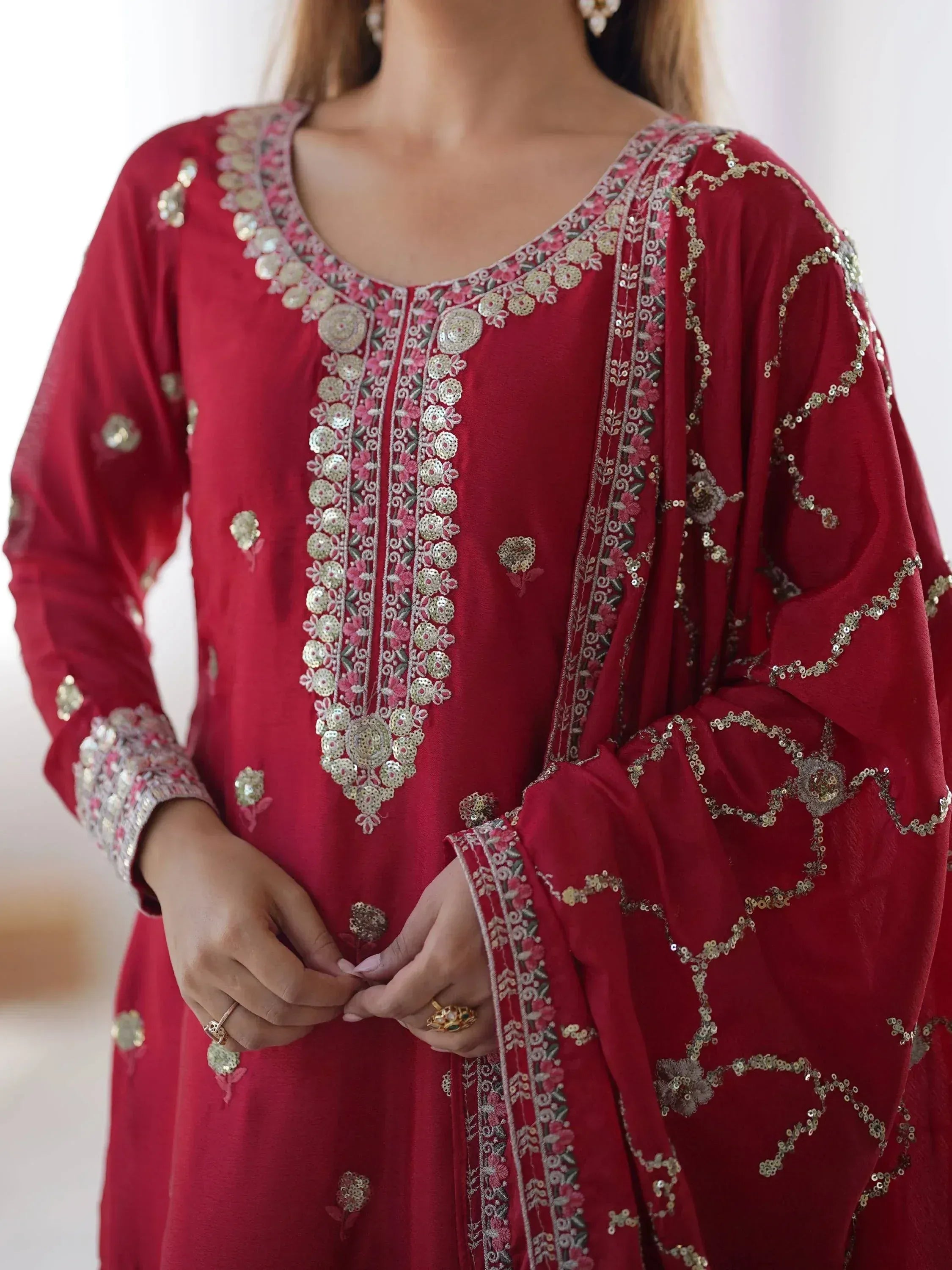 Red embroidered ethnic kurti with floral detailing and sequins, perfect for festive occasions.