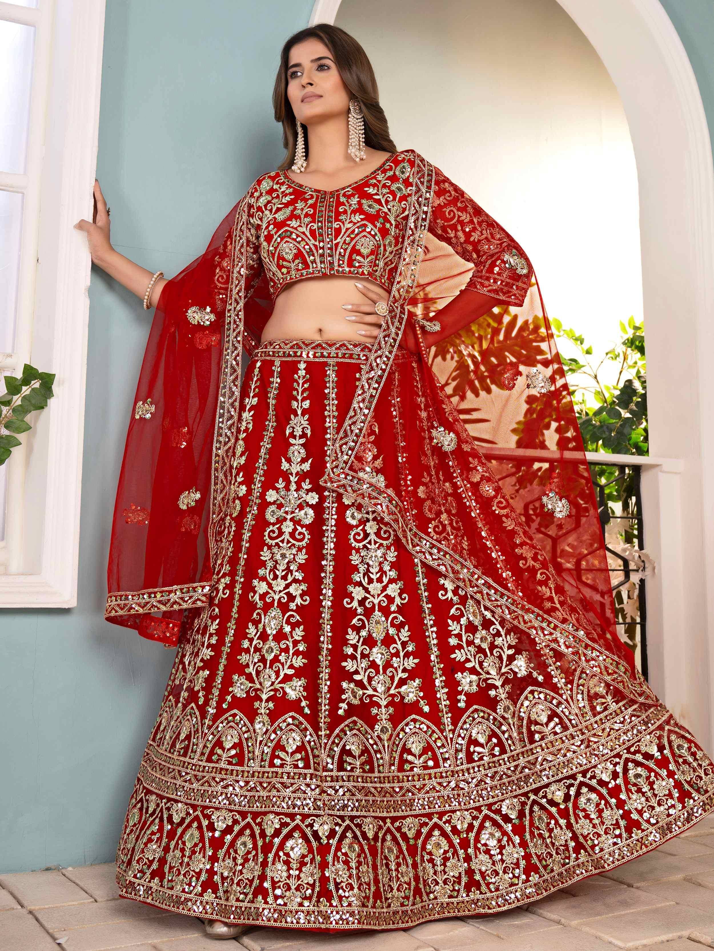 Red embroidered lehenga choli with gold detailing, perfect for Indian weddings and festive occasions.
