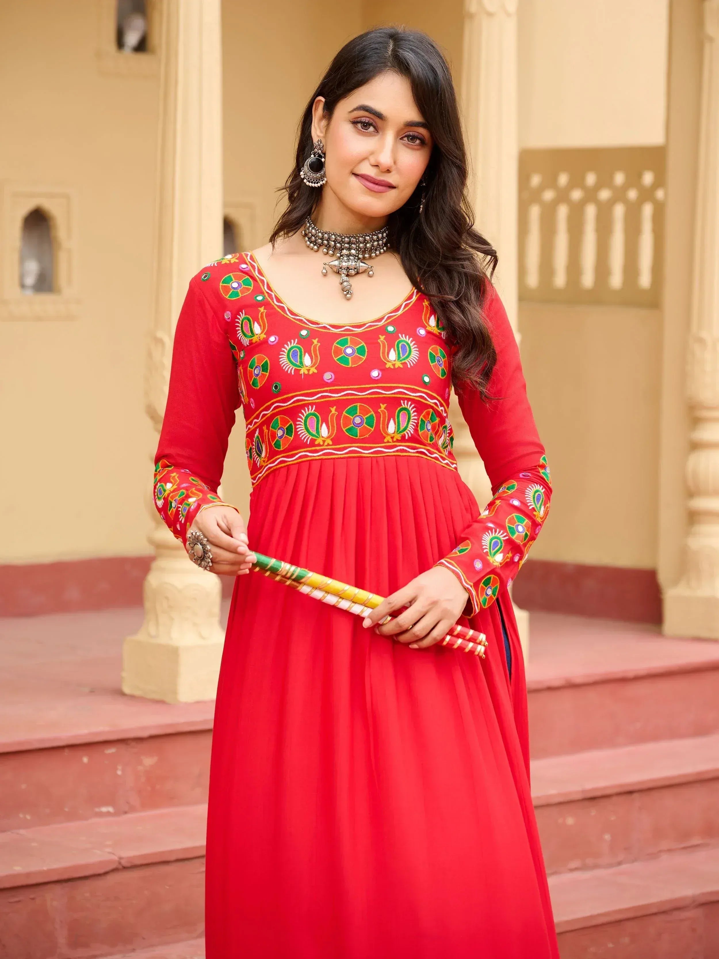 Red embroidered ethnic gown with peacock motifs, perfect for Indian festivals and occasions.