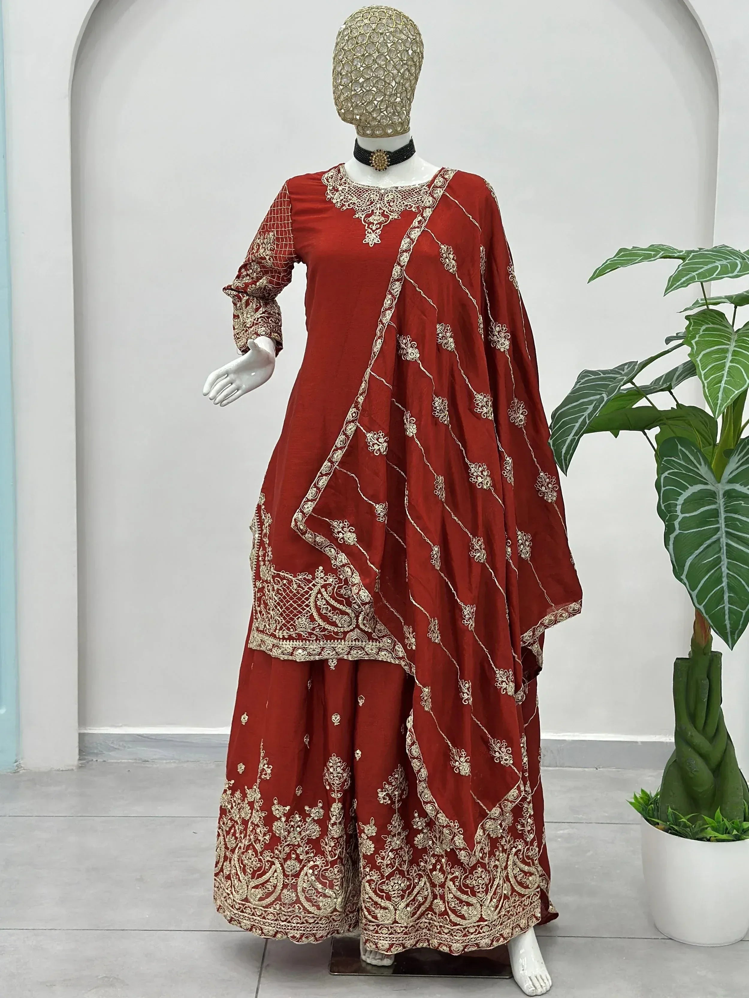 Red ethnic gown with gold embroidery, perfect for Indian weddings and festive occasions.