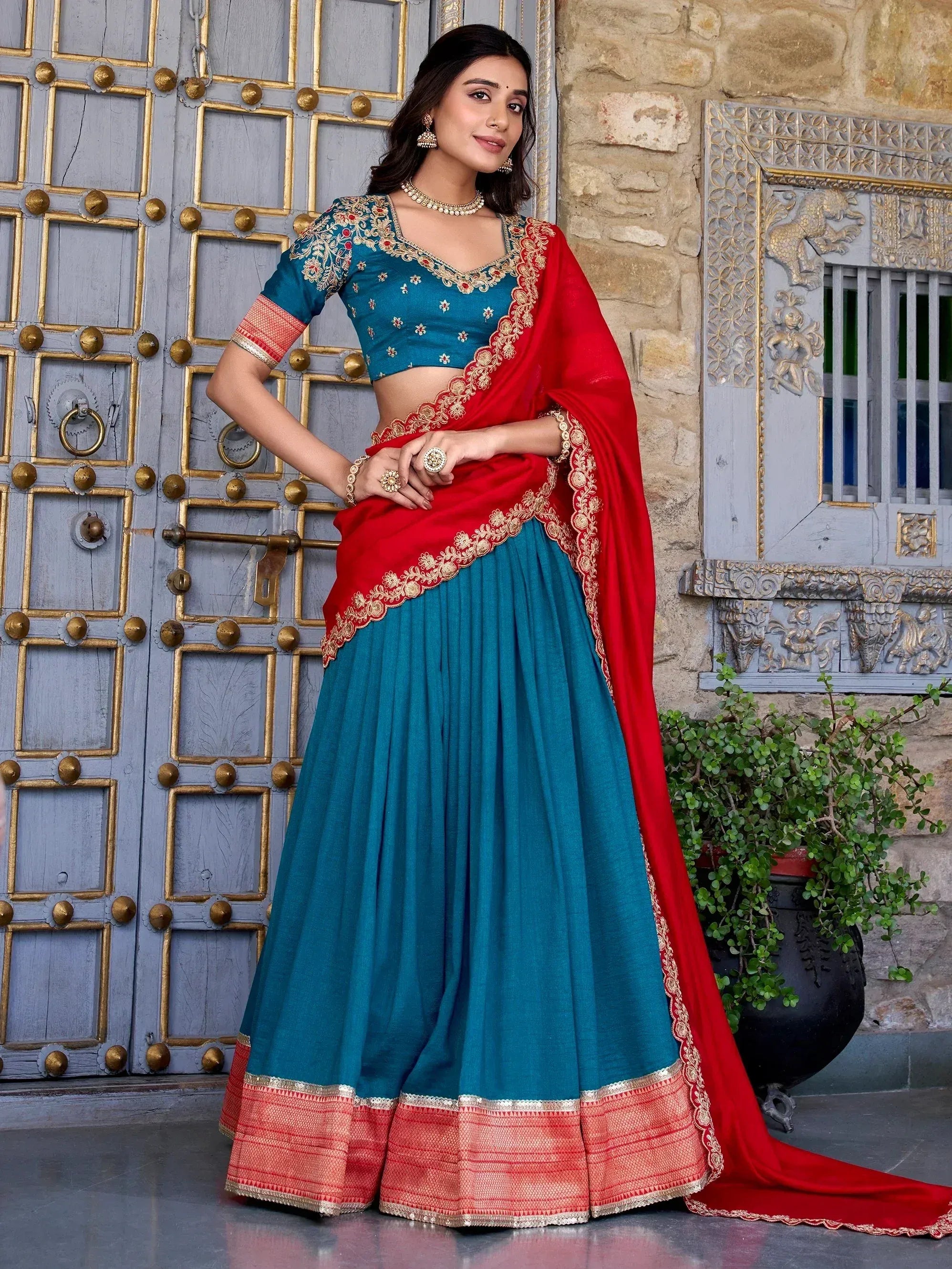 Teal and red embroidered lehenga choli with gold detailing, perfect for Indian ethnic wear occasions