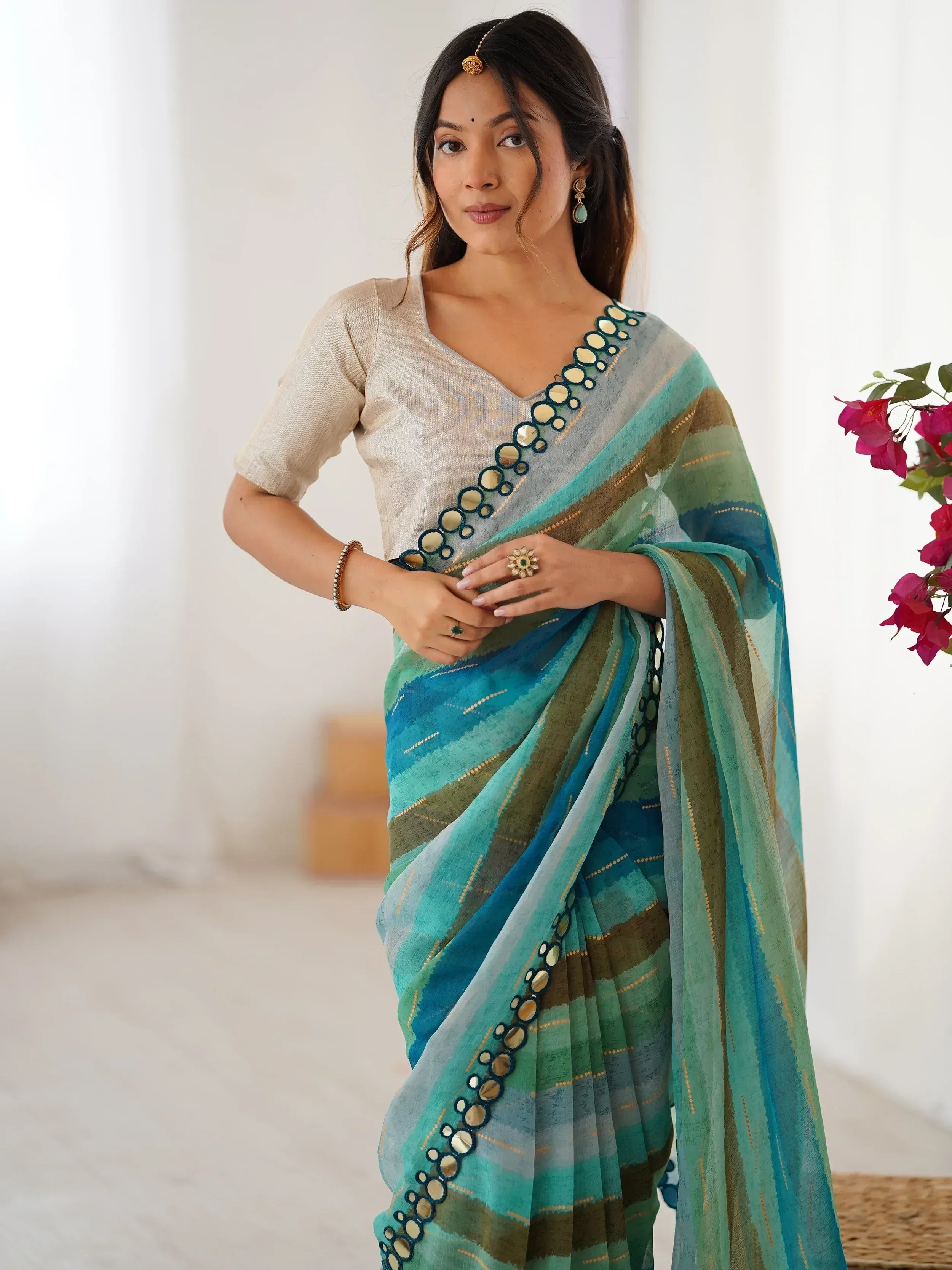 Woman in blue green striped saree with mirror work, ethnic Indian wear, stylish designer saree