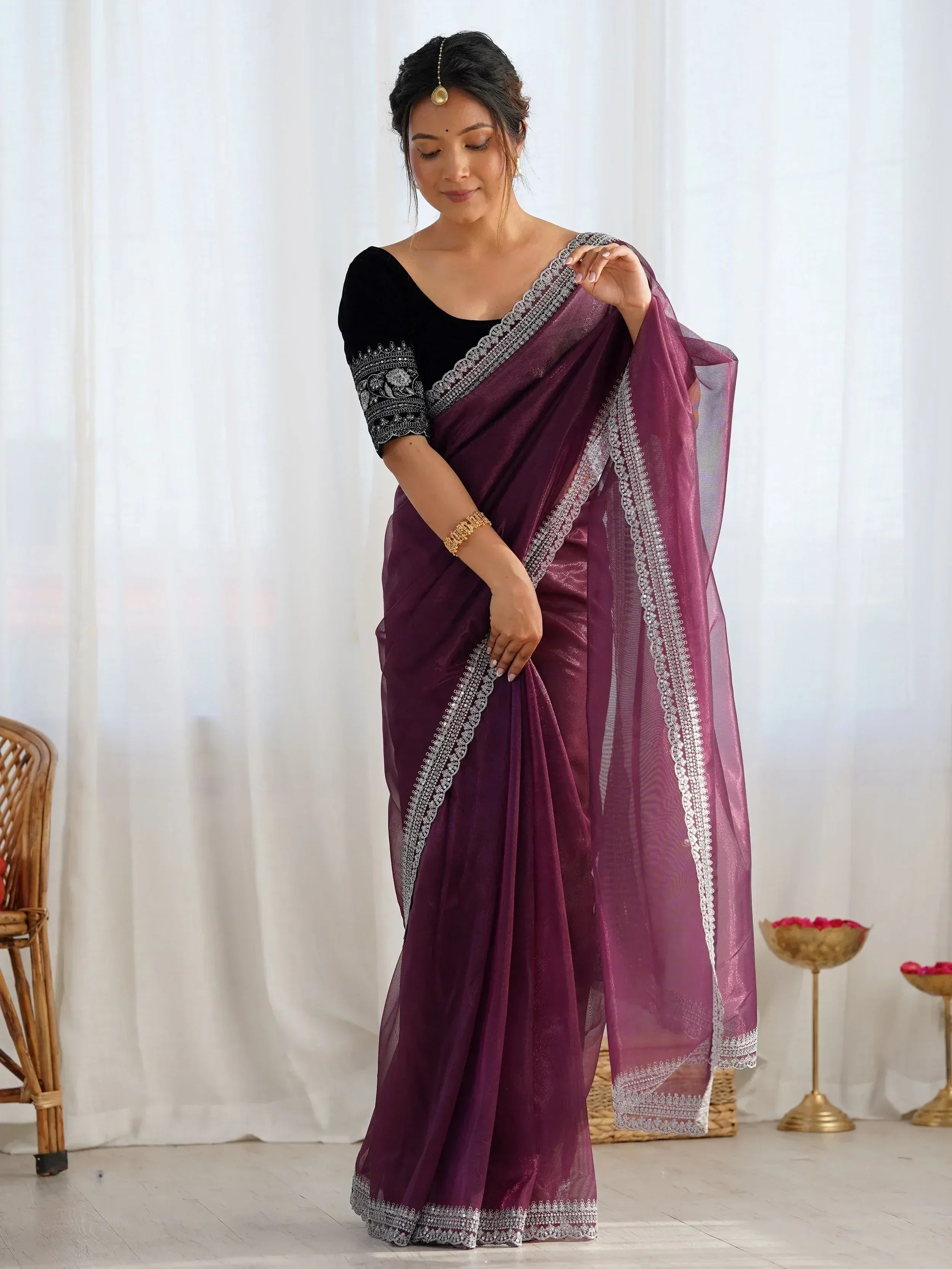 Elegant purple saree with silver embroidery, paired with black velvet blouse, perfect for Indian ethnic occasions.