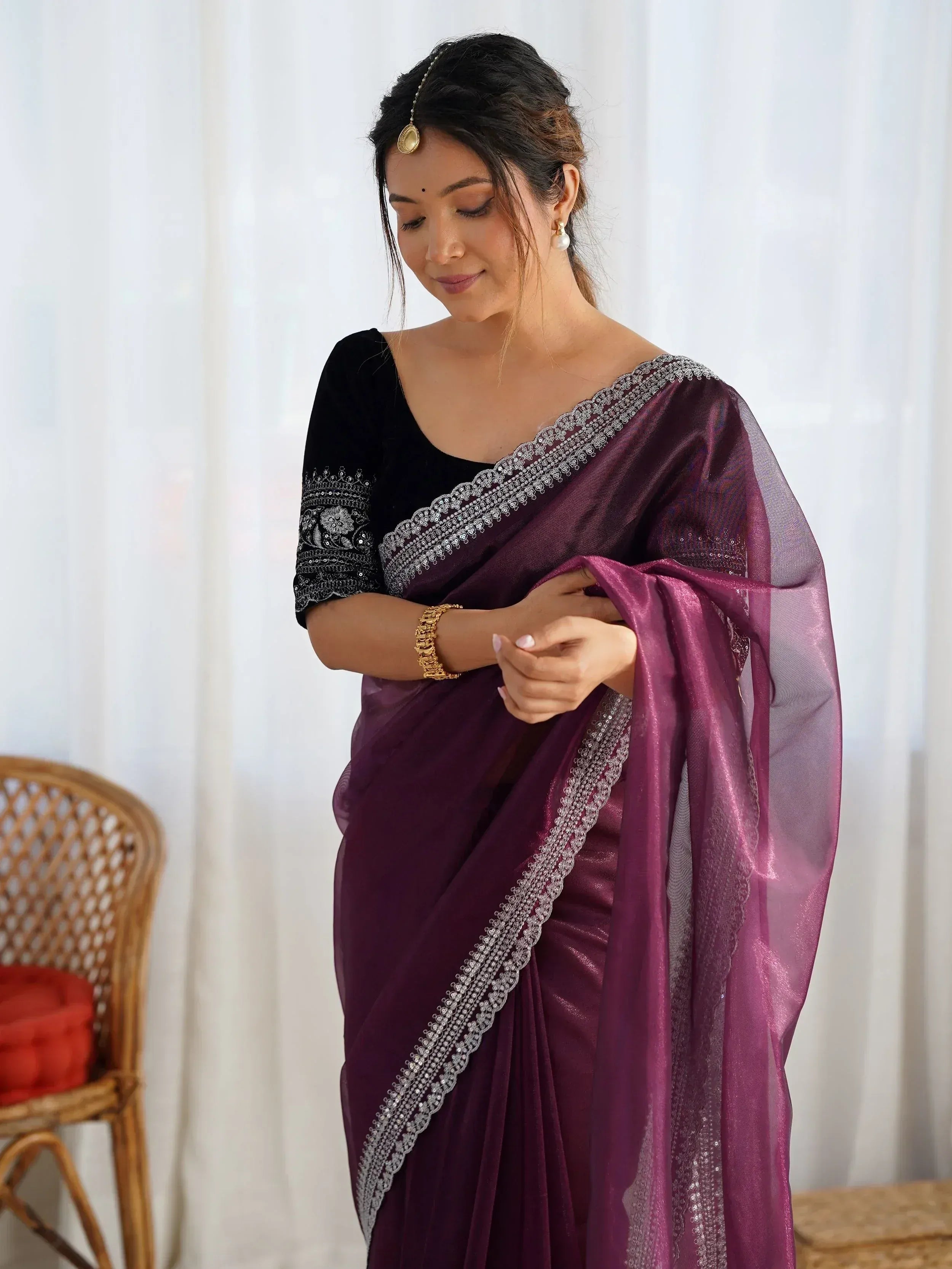 Woman in purple saree with silver embroidery and black velvet blouse, traditional Indian ethnic wear