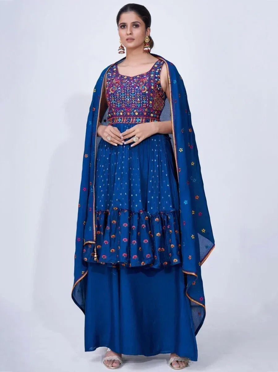 Woman wearing a blue embroidered ethnic lehenga choli with dupatta, Indian festive attire