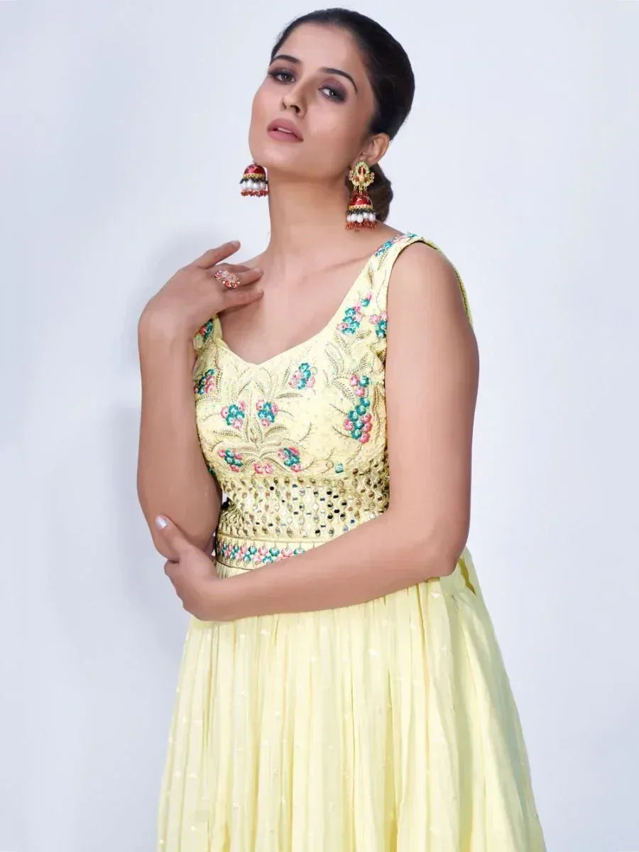 Yellow floral embroidered ethnic gown with mirror work, perfect for Indian festive occasions