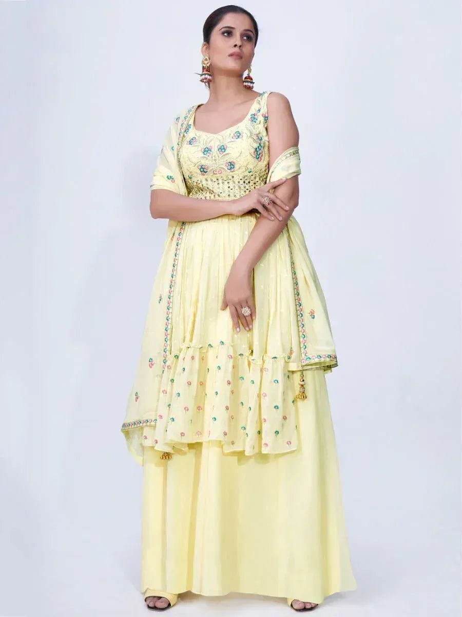 Yellow embroidered ethnic anarkali suit with floral detailing and layered skirt, perfect for festive occasions.