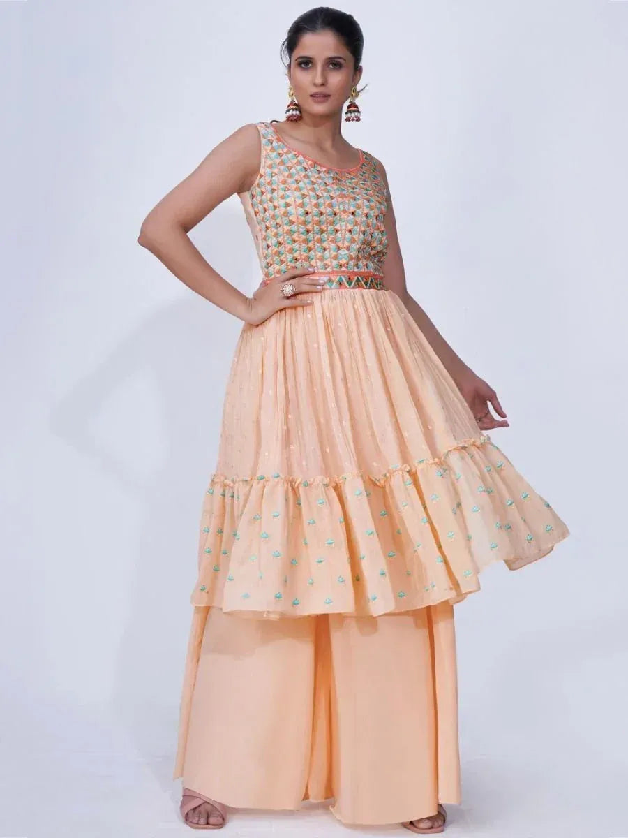 Peach ethnic gown with embroidered top and tiered skirt, paired with palazzo pants for festive occasions
